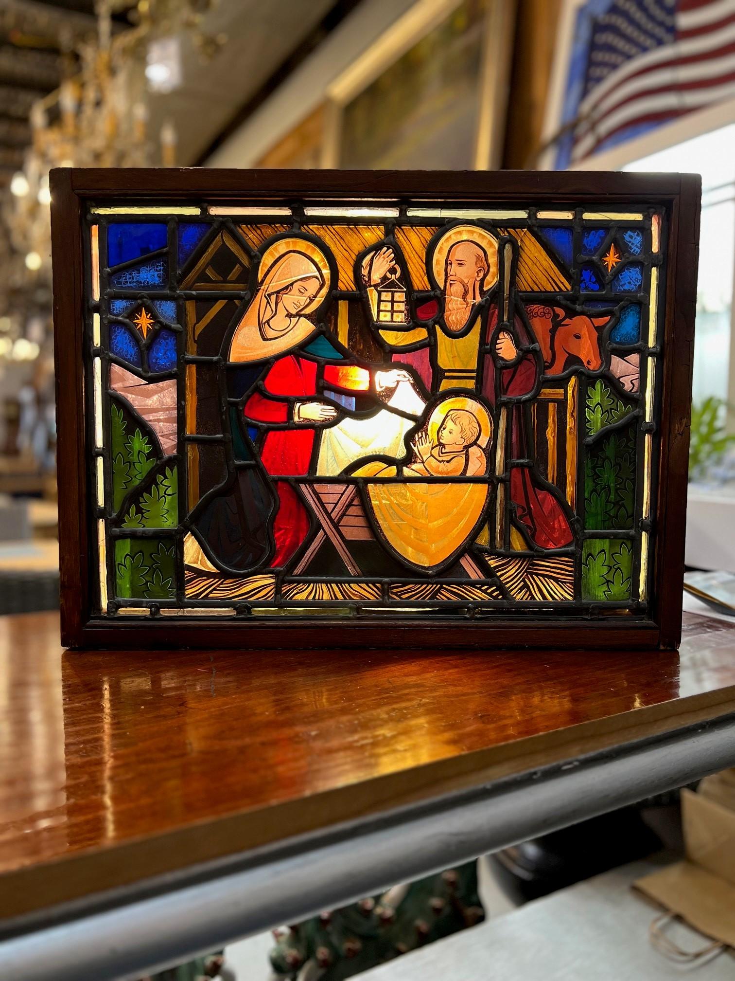 Early 20th century ( maybe older ) antique stained glass window of The Nativity in a shadow box with lights, a great piece. This is a beautiful window full of colors representing the birth of Jesus in a manger. The Nativity of Jesus has been a major