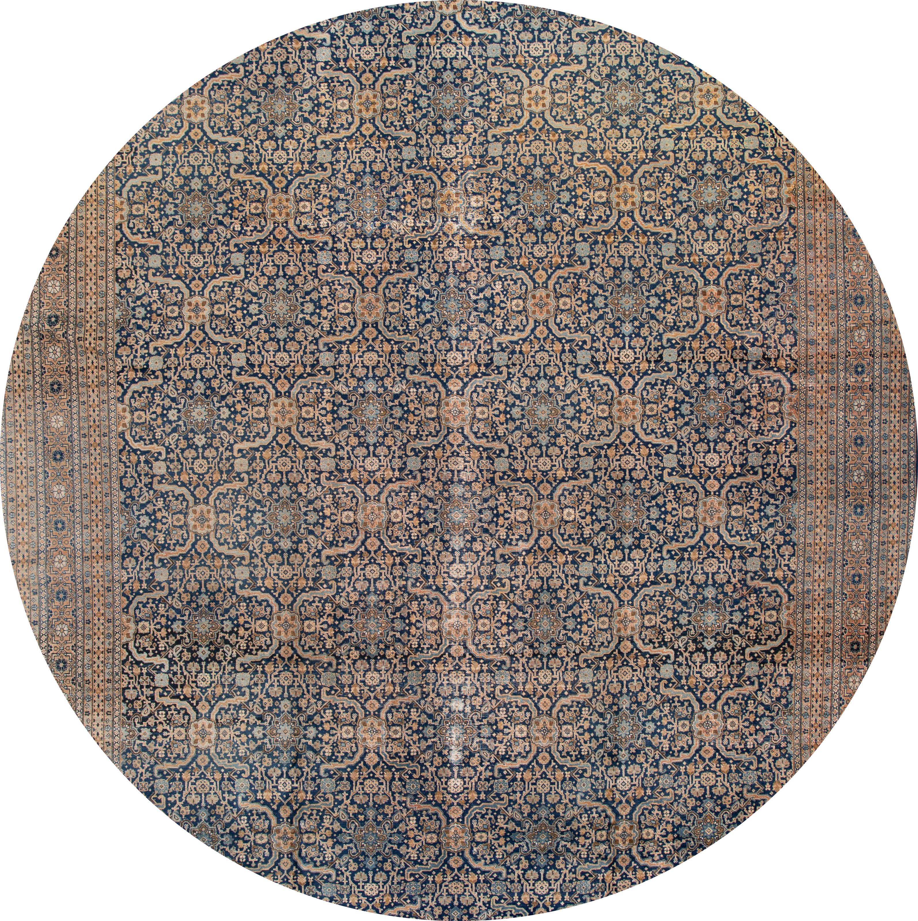 Beautiful antique oversize Tabriz rug, hand knotted wool with a blue field, tan and light blue frame and accents in an all-over design.
This rug measures 12' x 19'.