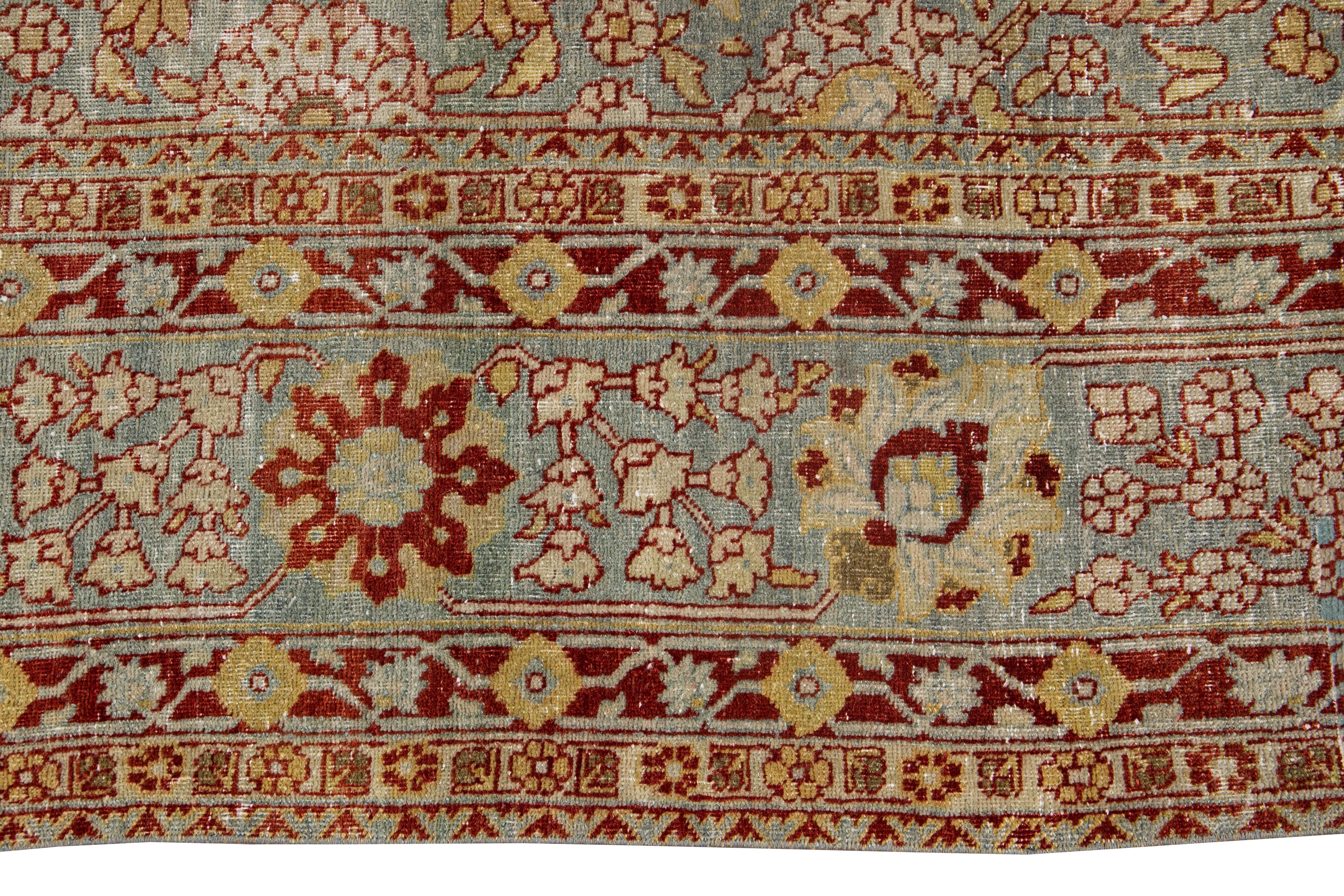 Beautiful Persian Tabriz rug, hand knotted wool with a light blue field, yellow and ivory accents in all-over floral design, circa 1920.
This rug measures 9' 0