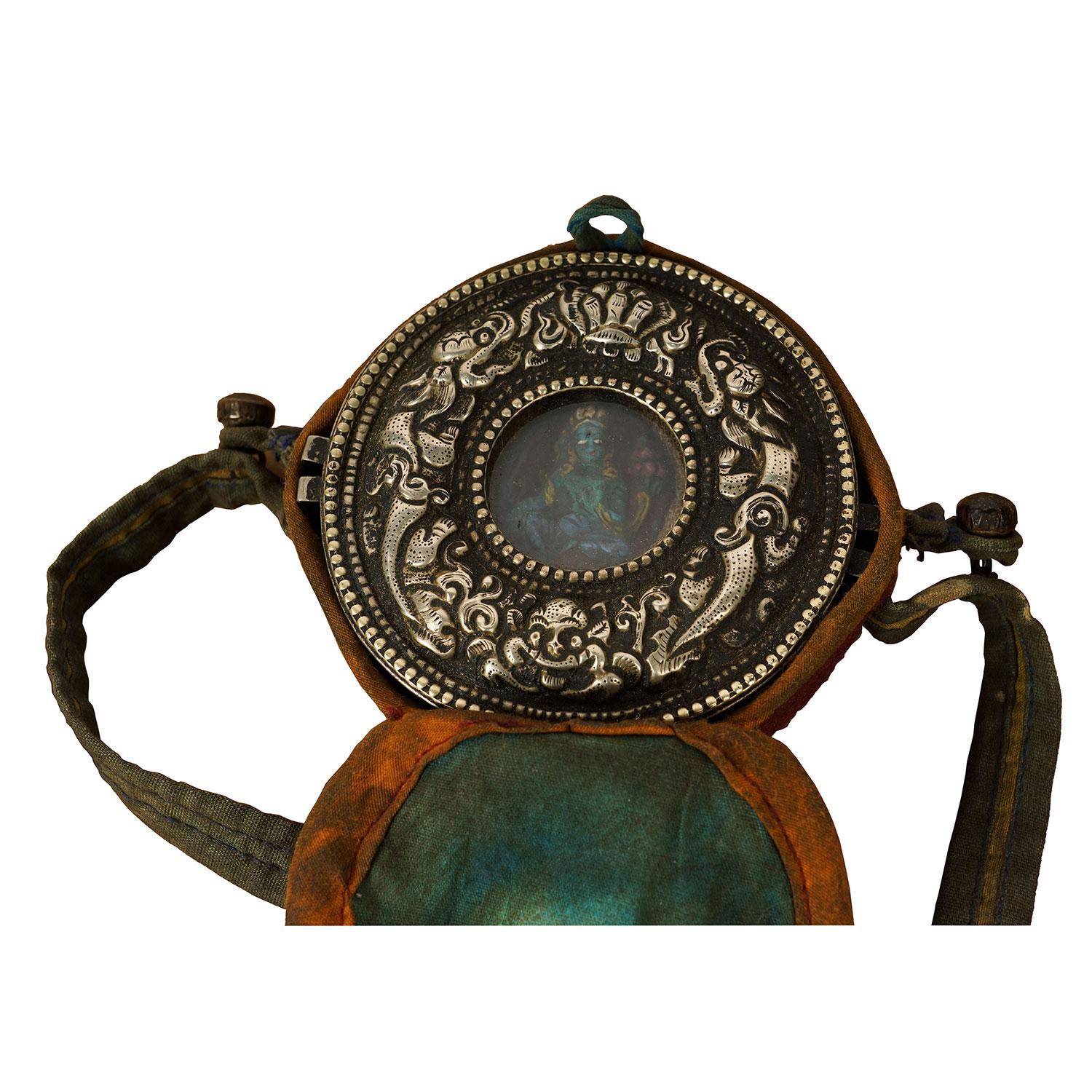 Ghau is a small prayer box worn as pendant by Buddhists as portable shrines which can be pray by prayer during their travel. This Ghau or prayer box made from Tibetan silver with a Turquoise Buddha inside. All hand made and hand carved.

Size: 1
