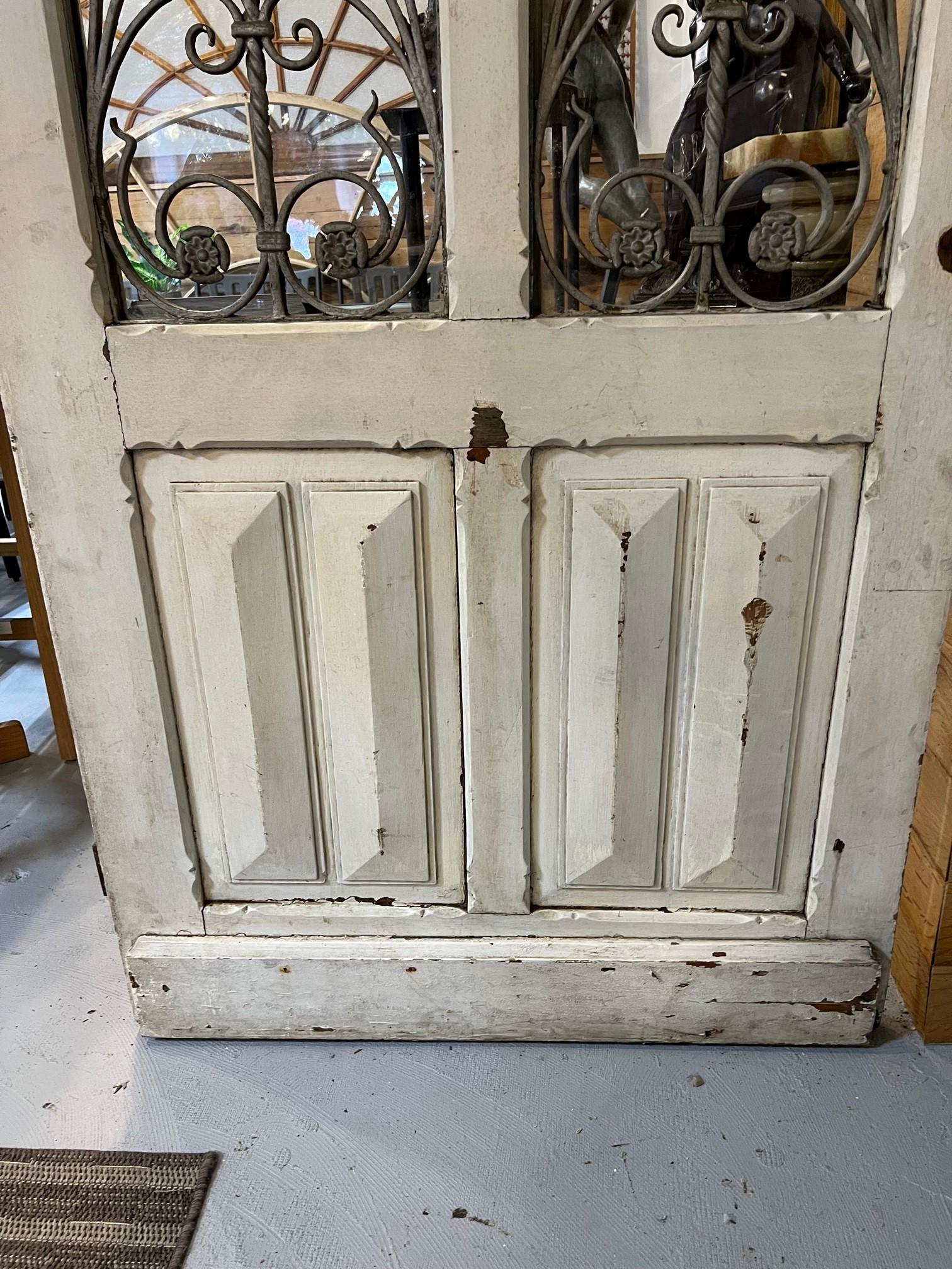 Early 20th Century Antique Wood Door with Iron Panels and Glass Door Panels In Good Condition For Sale In Stamford, CT