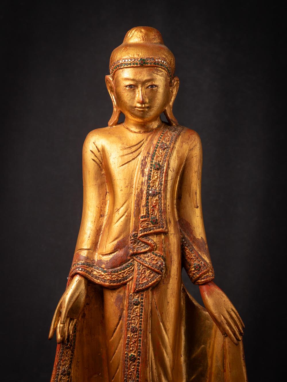 This Antique wooden Mandalay Buddha statue from Burma during the Early 20th century, is a fine example of Mandalay style craftsmanship. It stands at a height of 89 cm and boasts dimensions of 35,8 cm in width and 20,1 cm in depth, making it a