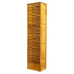 Early 20th century apothecary fruitwood tall chest of drawers