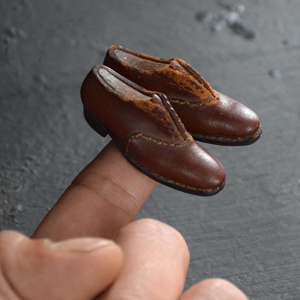 Early 20th Century Apprentice Shoes 

A rare and delightful pair of leather early 20th Century hand crafted apprentice shoes. One of the smallest examples we have seen to date. 

Size in inches: H 0.8” x W 2” x D 0.4”

Completely solid in