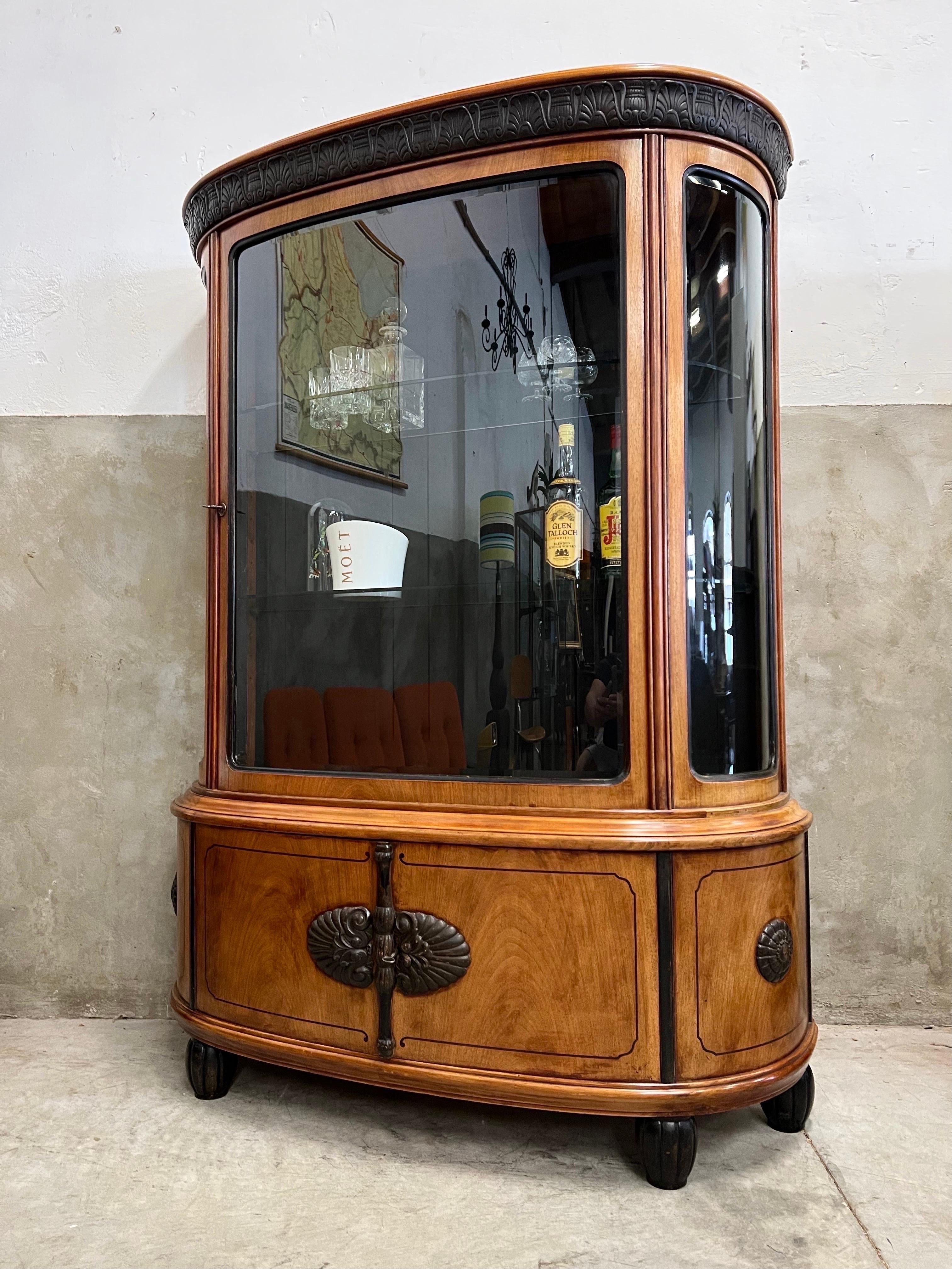 This Art Deco Beverage cabinet, display cabinet is a gem in itself and there is only 1 of them

Real piece of craftsmanship made around 1910-1920 in with its curved glass doors and sides, the glass itself is also cut.

Beautiful ornaments and