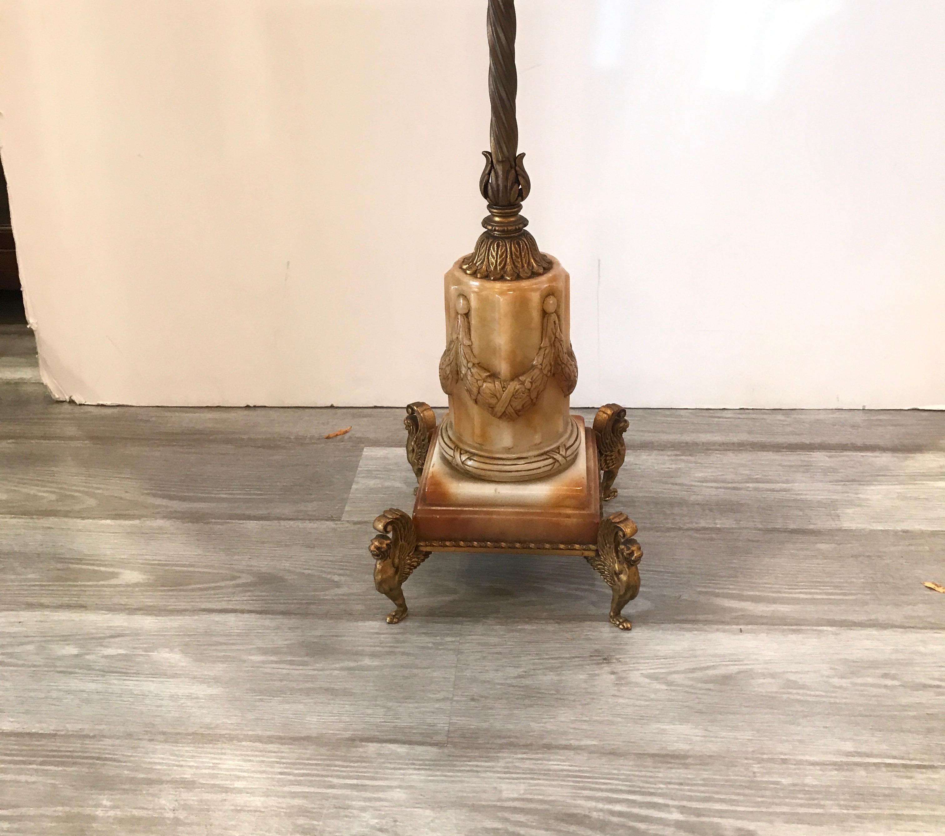Exceptional cast and gilt bronze floor lamp with marble base. The floor lamp designed by renowned maker Oscar Bach with four sockets with the original detailed finial. The shade is for photographic purposed only and not included.