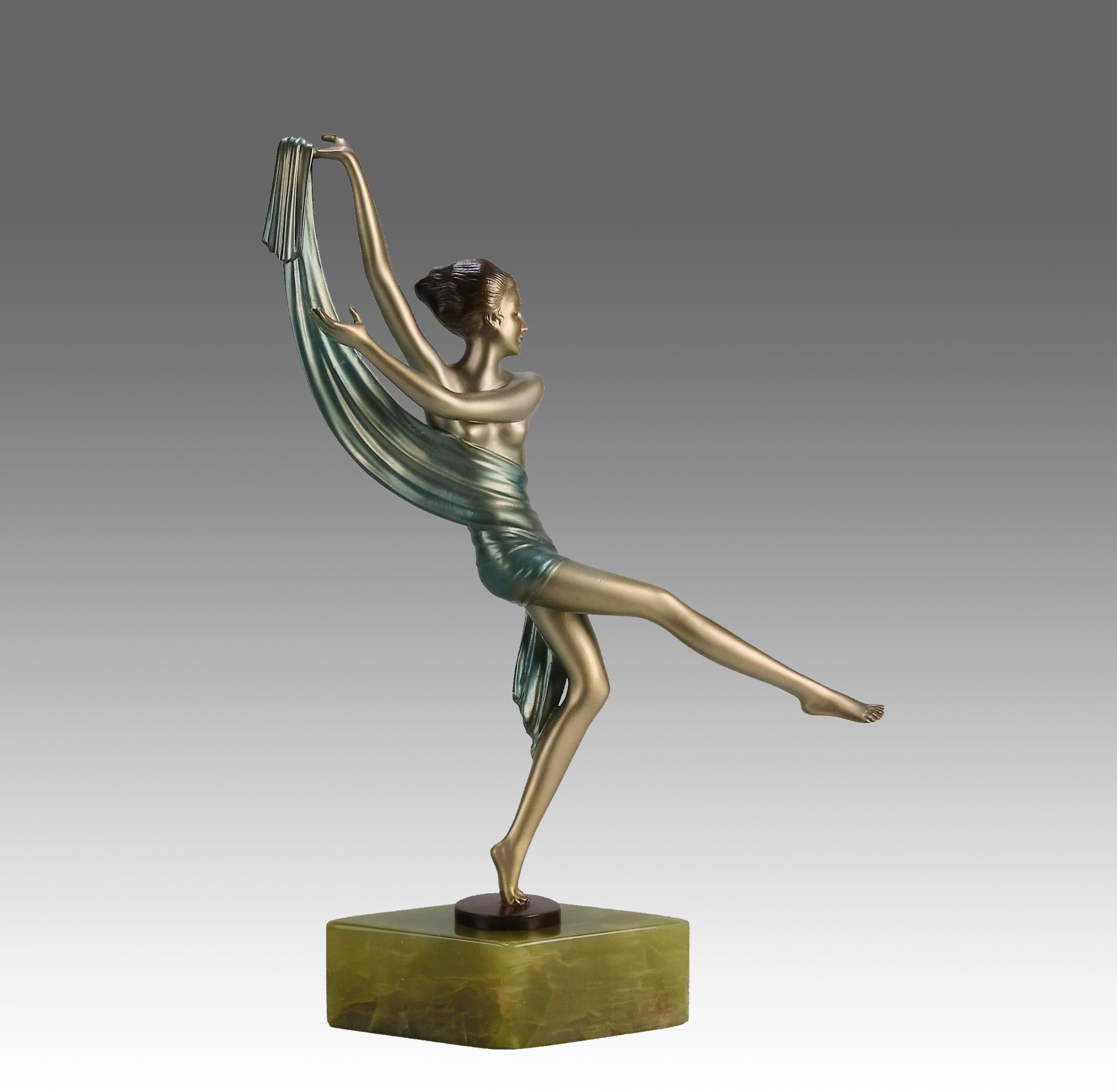 An impressive early 20th Century Art Deco cold painted gilt and enamel bronze figure of a young energetic beauty in a balanced dancing pose with a scarf draped around her midriff. The bronze exhibiting excellent colour and very fine hand chased