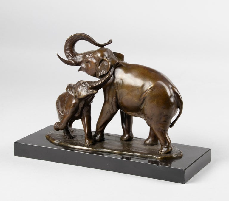 A fine bronze casted sculpture of a Elephant with a calf, resting on a black Belgium marble base. The bronze has the original olive-brown patina. It is made in France, circa 1930-1940. Signed: Irénée ROCHARD. The sculpture has a beautiful patina and