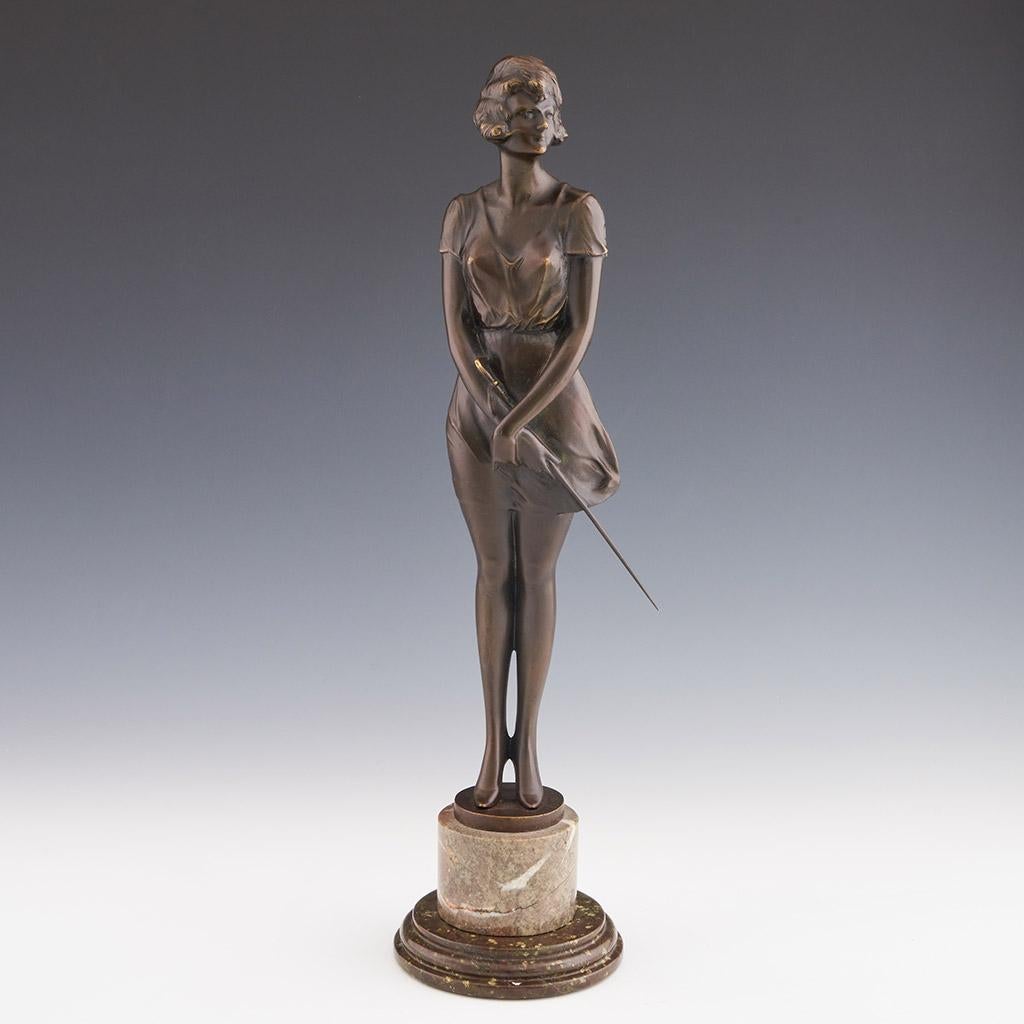 A fabulous Art Deco bronze figure of a beautiful woman wearing a loose fitted figure hugging dress and high heels holding a riding whip, with excellent colour and very fine hand finished detail, signed Bruno Zach
ADDITIONAL INFORMATION

Height:     