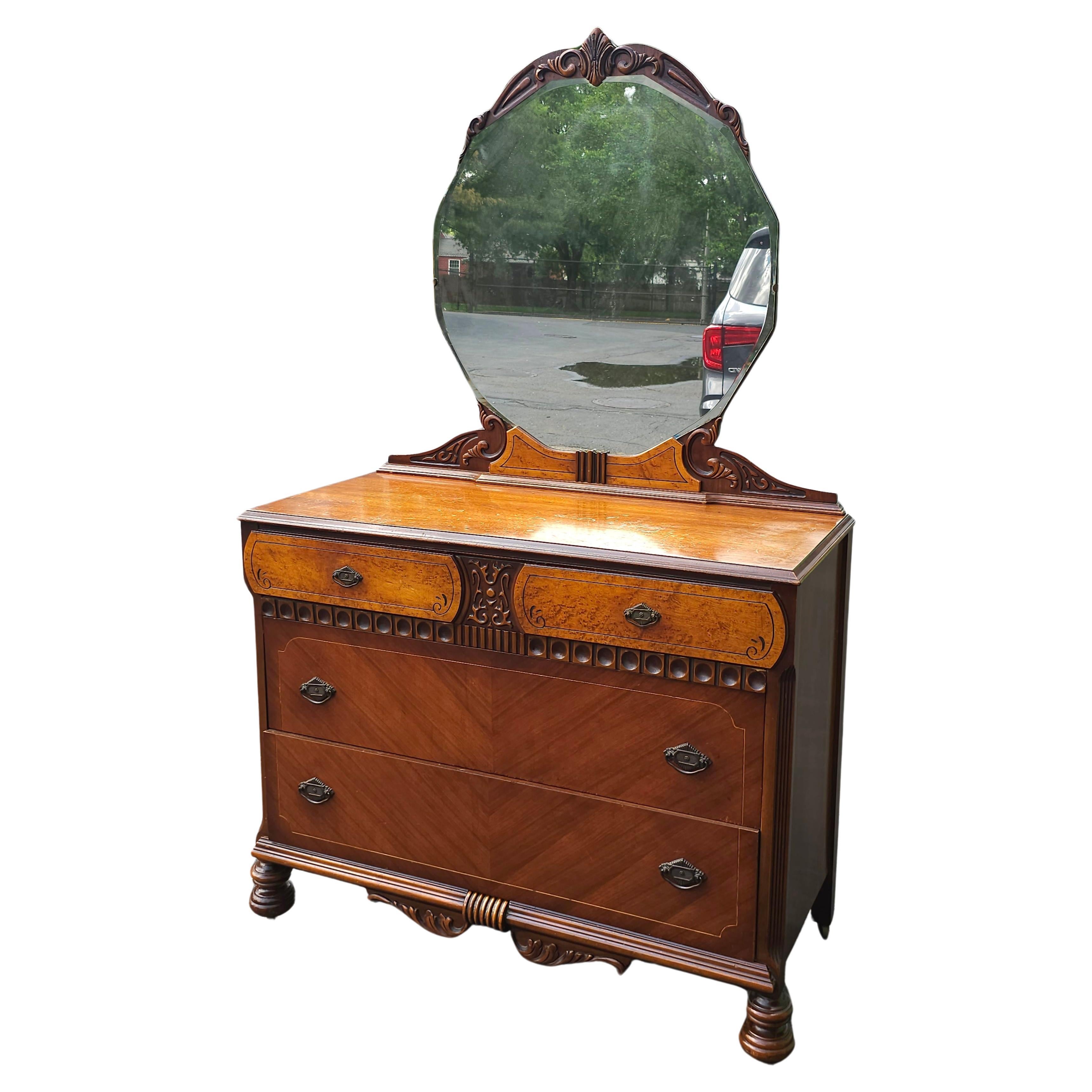 An Early 20th Century Art Deco Chest Mahogany and Walnut 4 drawer Chest of Drawers with Mirror on original wooden wheels under William and Mary style legs. Use with or without mounted mirror. Measures 44