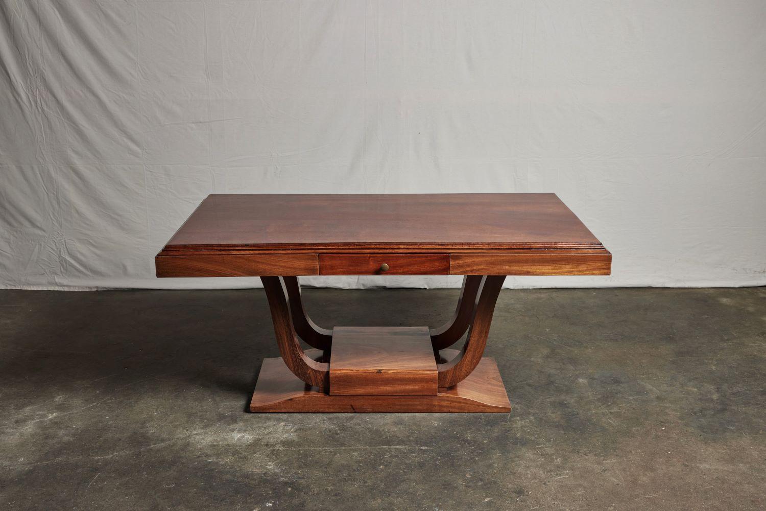 A French Colonial rosewood desk of distinctive and graceful design. 1930s with one pencil drawer.