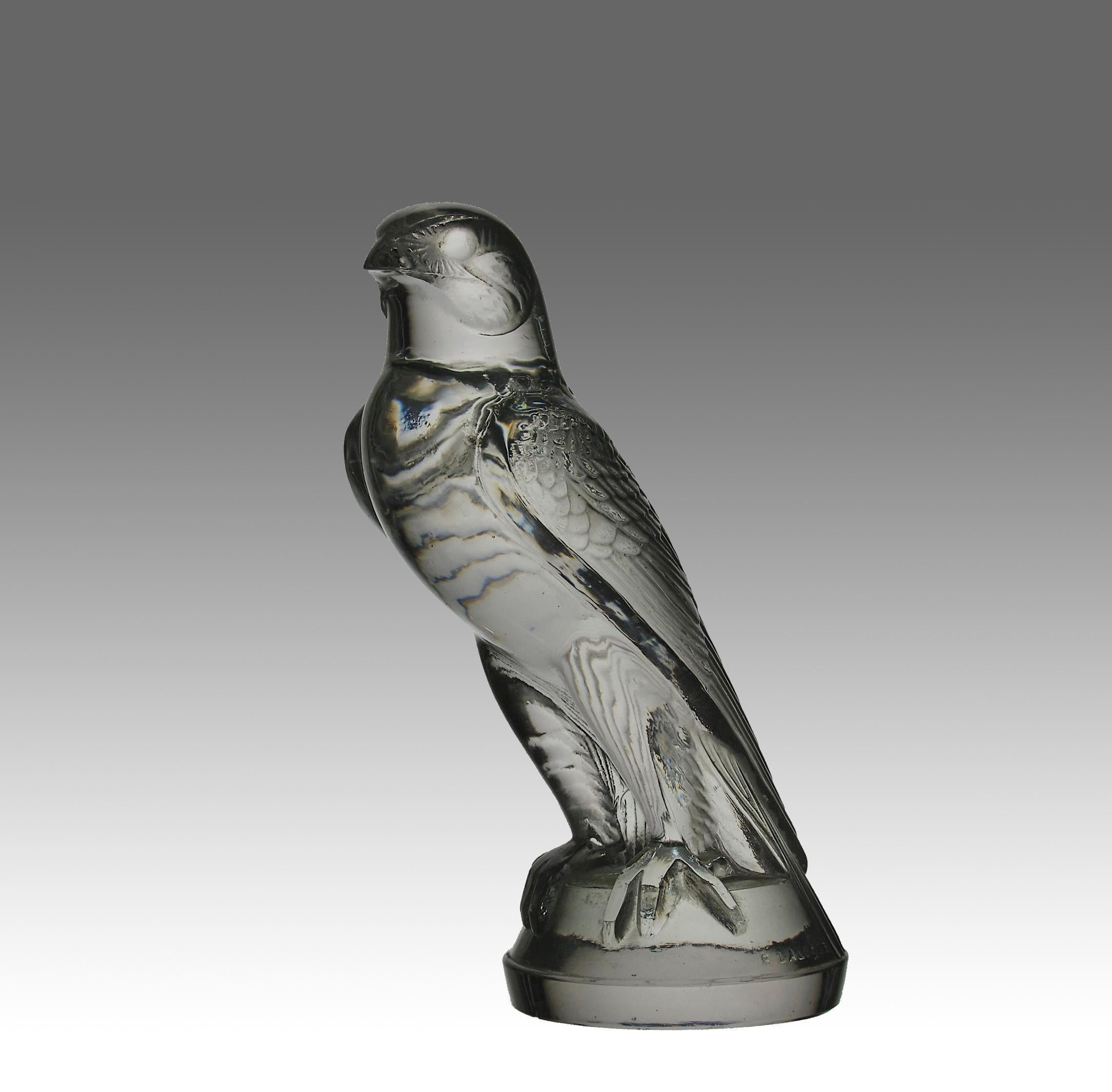 Dramatic early 20th Century French Art Deco clear glass car mascot modelled as a standing falcon with good hand finished detail, signed R Lalique and France 

'Faucon' Bouchon de Radiateur
Catalogue Number: 1124
Signature Identification: “R.