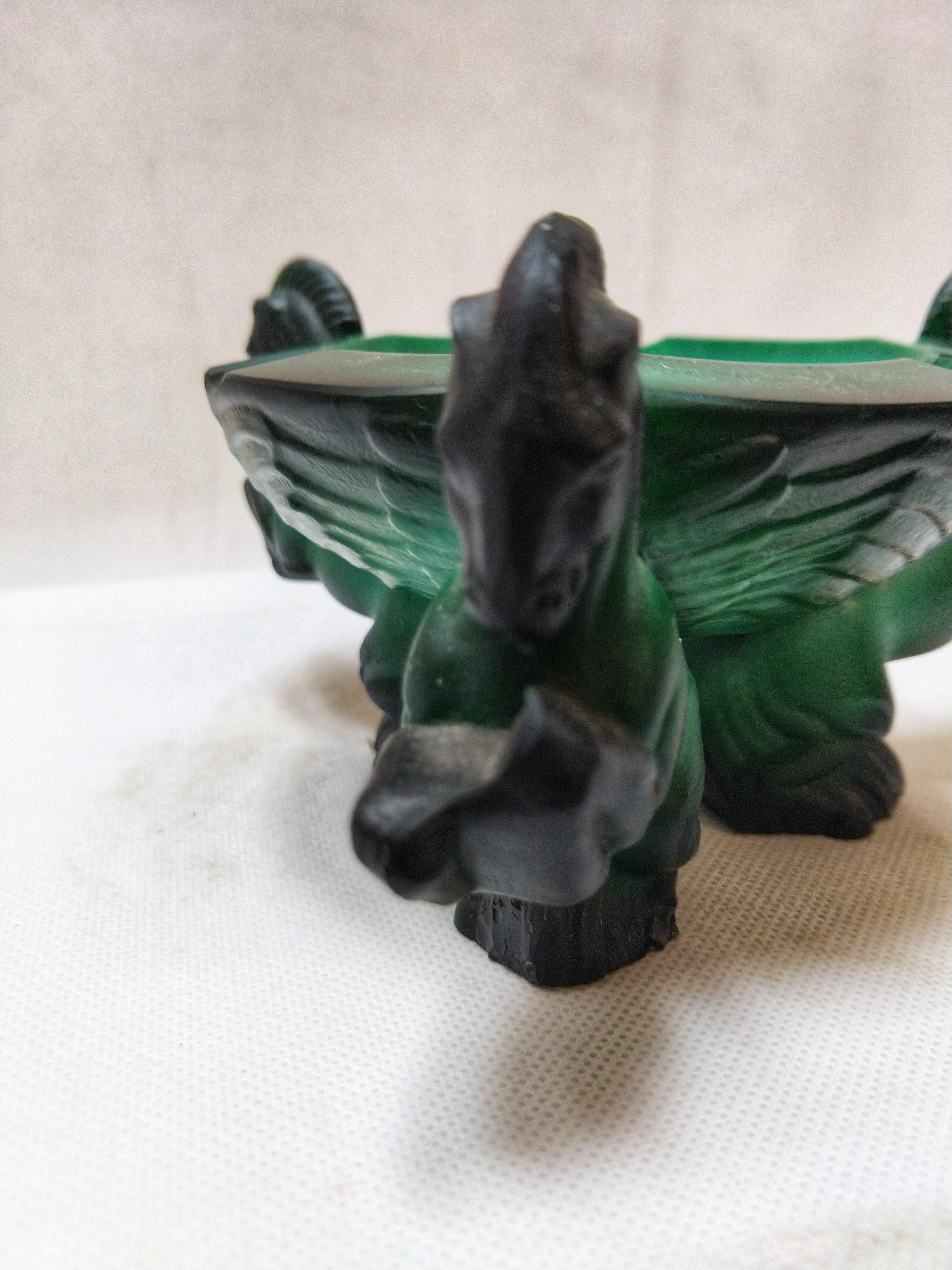 Beautiful ashtray in malachite Moser from the early 1900s with three rampant horses.

Malachite is a copper carbonate hydroxide mineral, with the formula Cu2CO3(OH)2. This opaque, green banded mineral crystallizes in the monoclinic crystal system,
