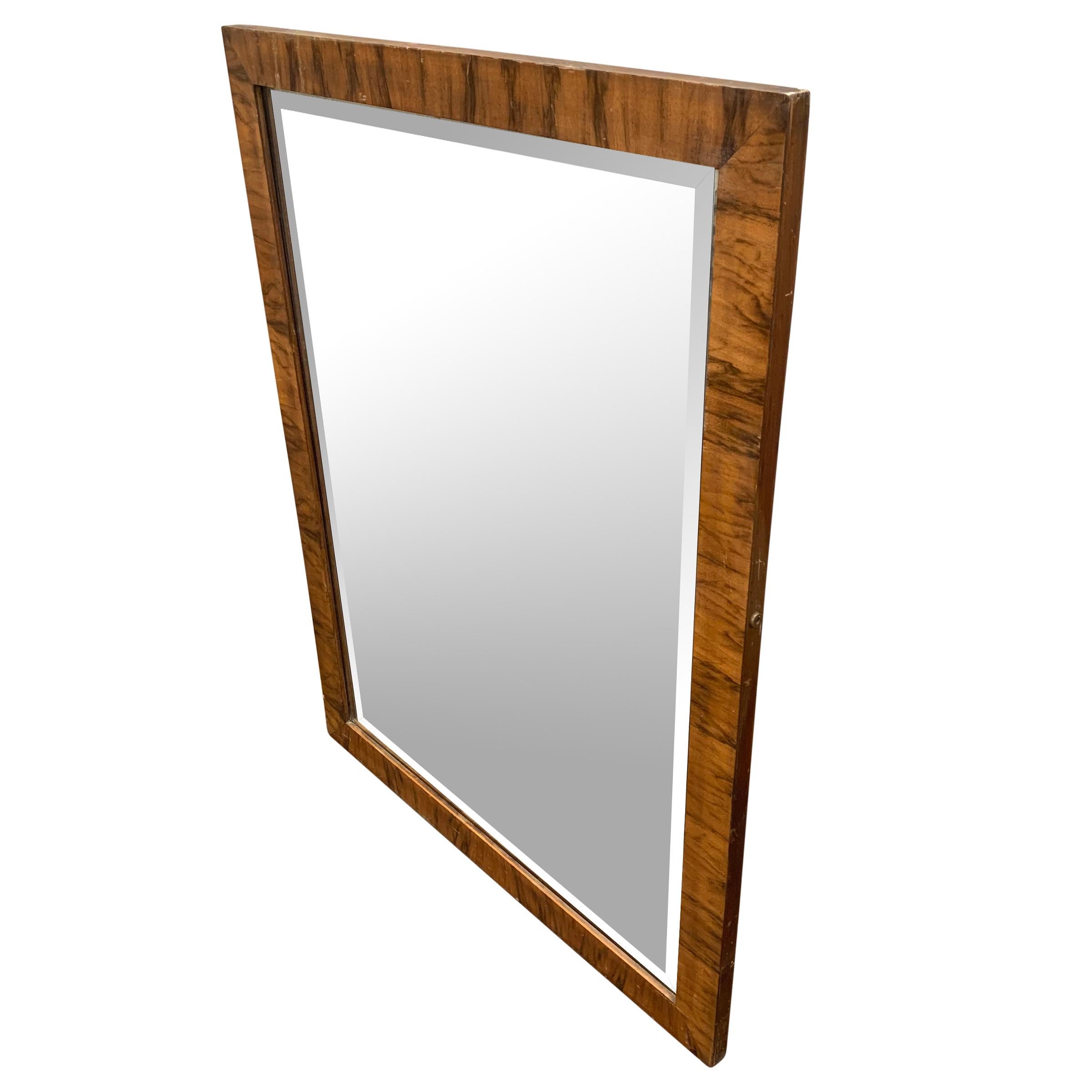 A wonderful early 20th century American Art Deco mirror with a beautiful bookmatched crotch rosewood veneer and it's original beveled glass.