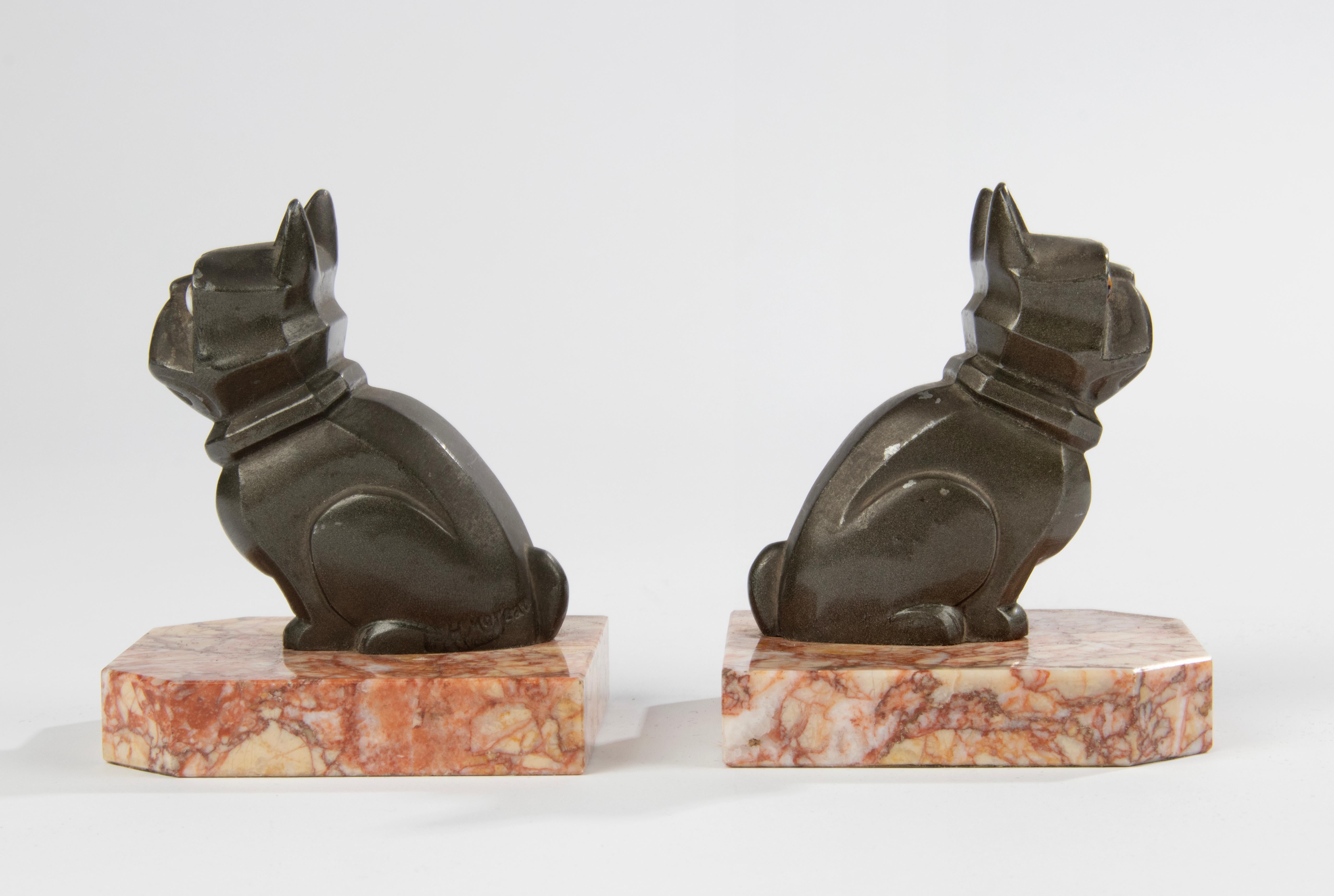 A pair of Art Deco period patinated spelter (metal alloy) bookends with cubistic sculpted French bulldogs with glass eyes, on a marble plinth. Signed H. Moreau. The bulging glass eyes have an amusing expression. The sculptures are still in beautiful