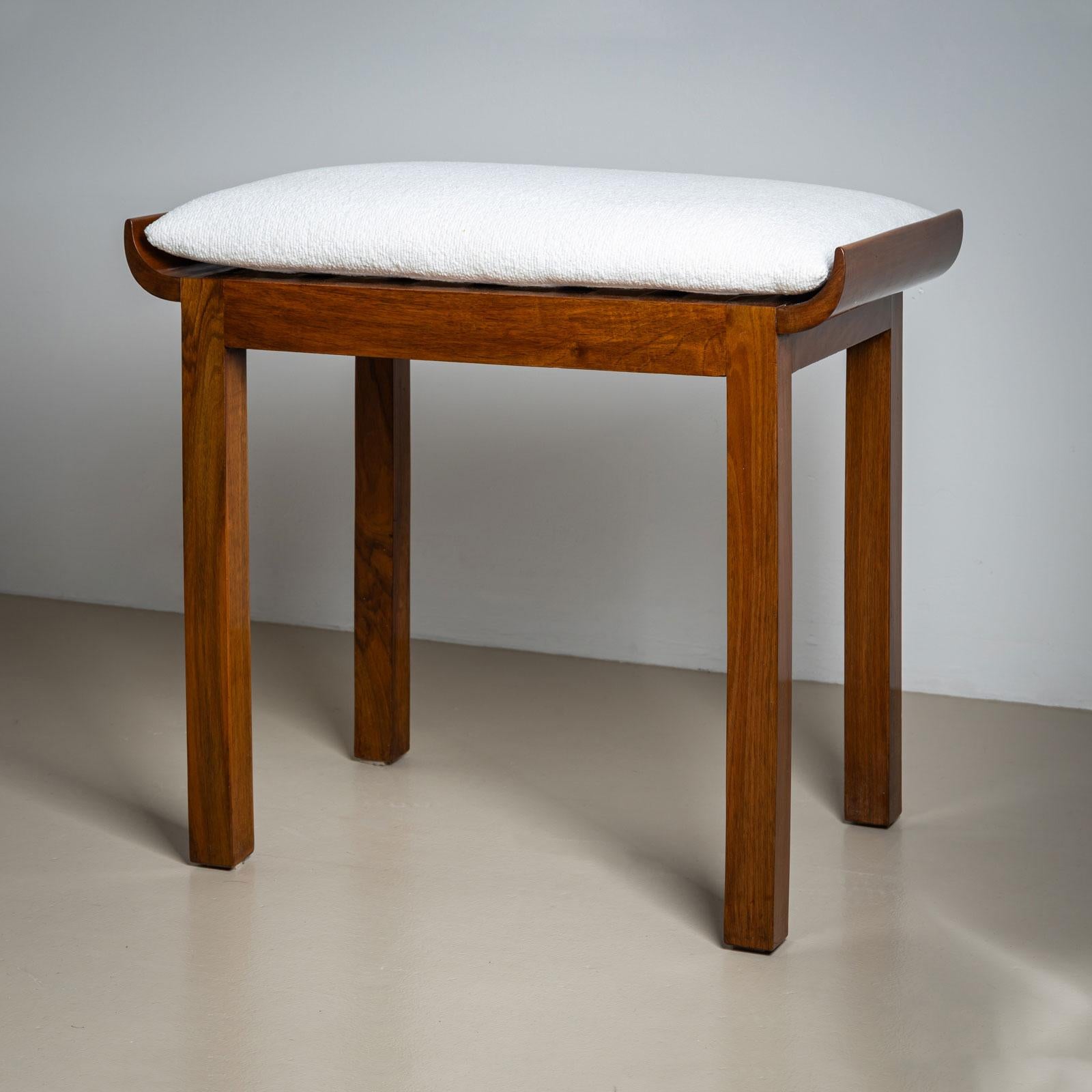 

An elegant, minimalist Art Deco stool from France, crafted circa 1920. Made from high-quality walnut, the stool stands on straight square legs. Its pagoda-shaped seat with gently rounded sides adds a touch of subtle dynamism to the design.

The