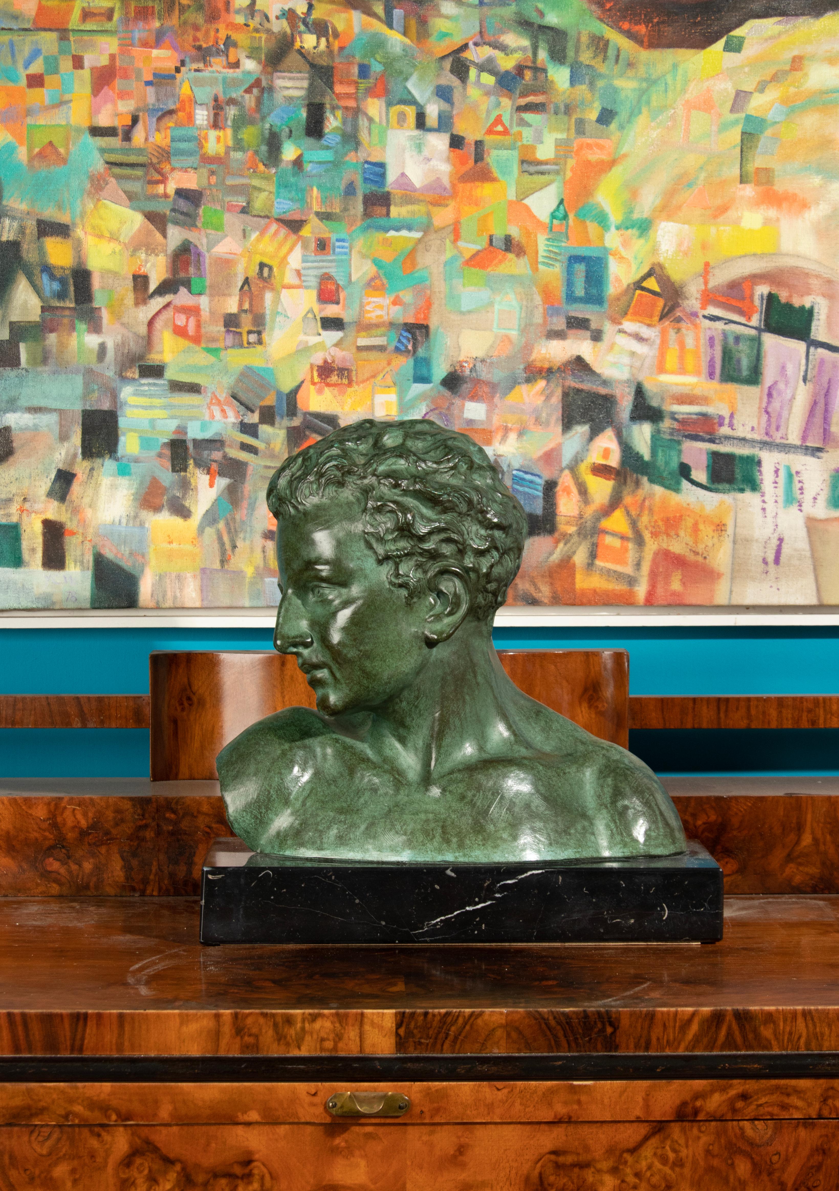 An Art Deco sculpture of a young man, made of terracotta. With a beautiful green patina. On a Black Belgian marble pedestal. In a good and original condition. Made in Belgium, circa 1920-1930 by the Italian sculptor Giuseppe Carli.

The Carli