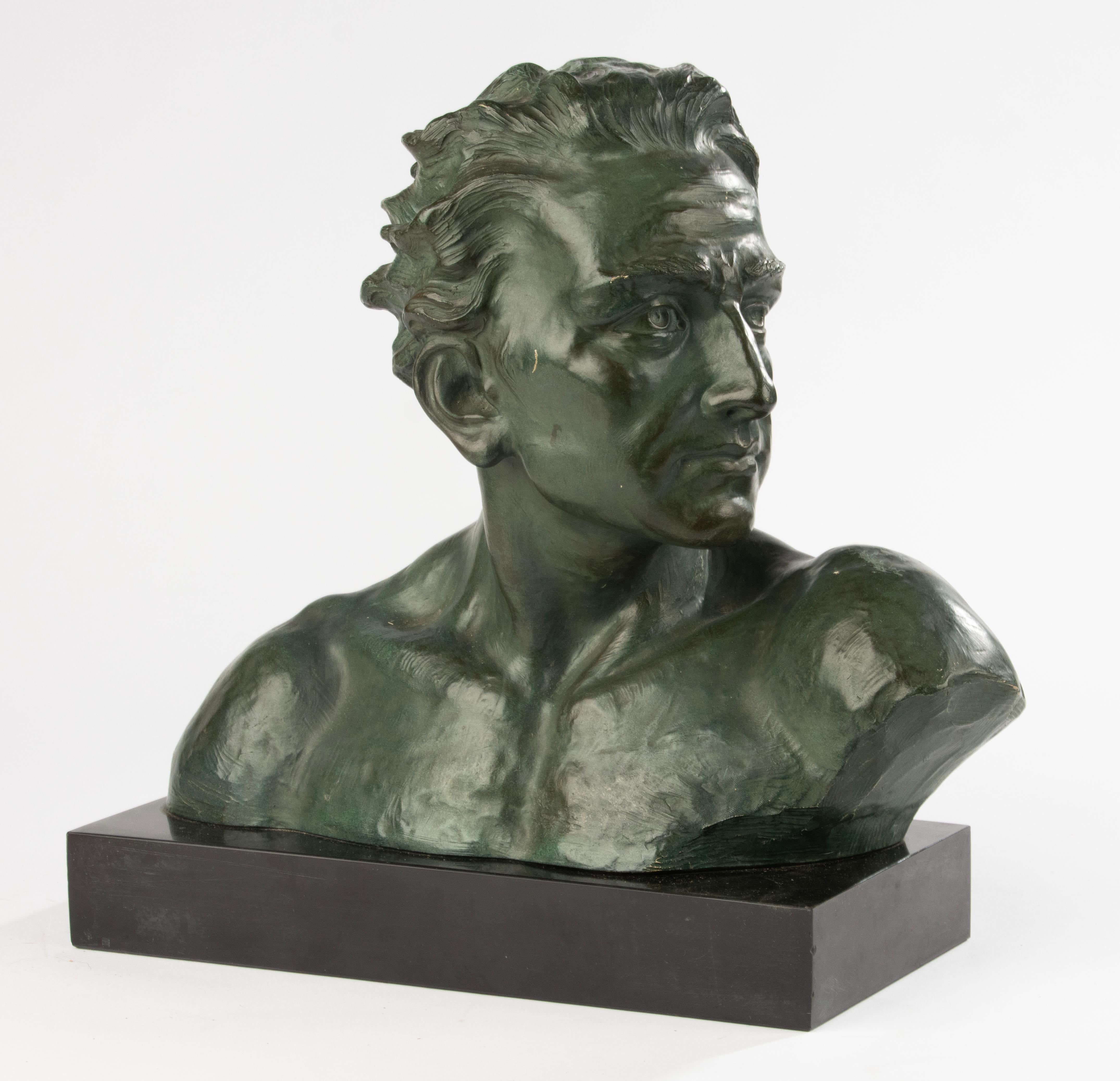 Striking Art Deco terracotta bust, beautifully patinated in deep green tones, depicting a strong male portrait with a dynamic, expressive profile. The sculpture captures both vitality and elegance, characteristic of early 20th-century portrait