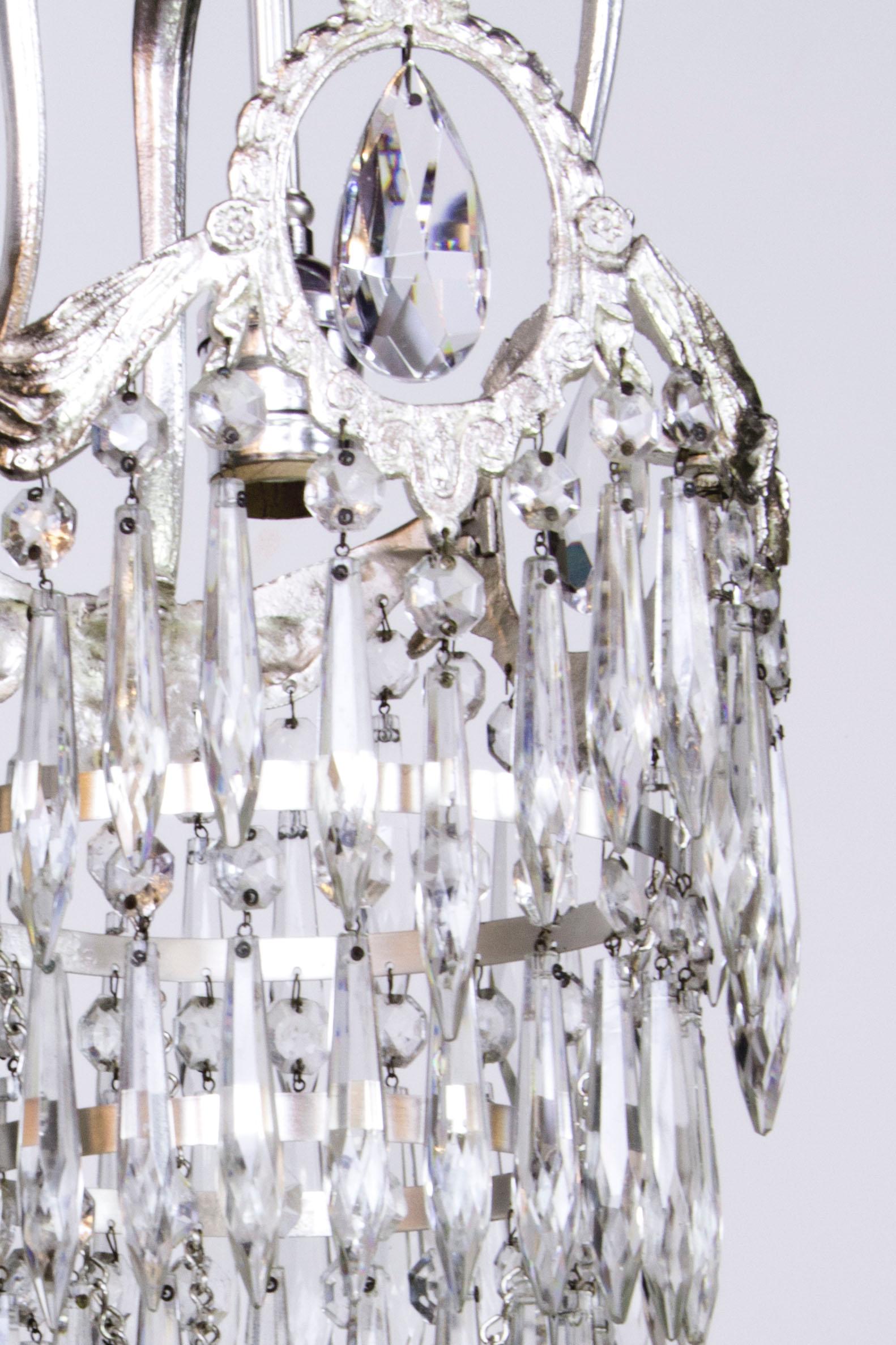 Silver plate fixture with crystal. sculptural crown with keyhole crystal and tiers of crystals cascading below. Add a touch of glamor to a powder room, small hallway, or boudoir. Completely restored and rewired, ready to hang. This pendant has a