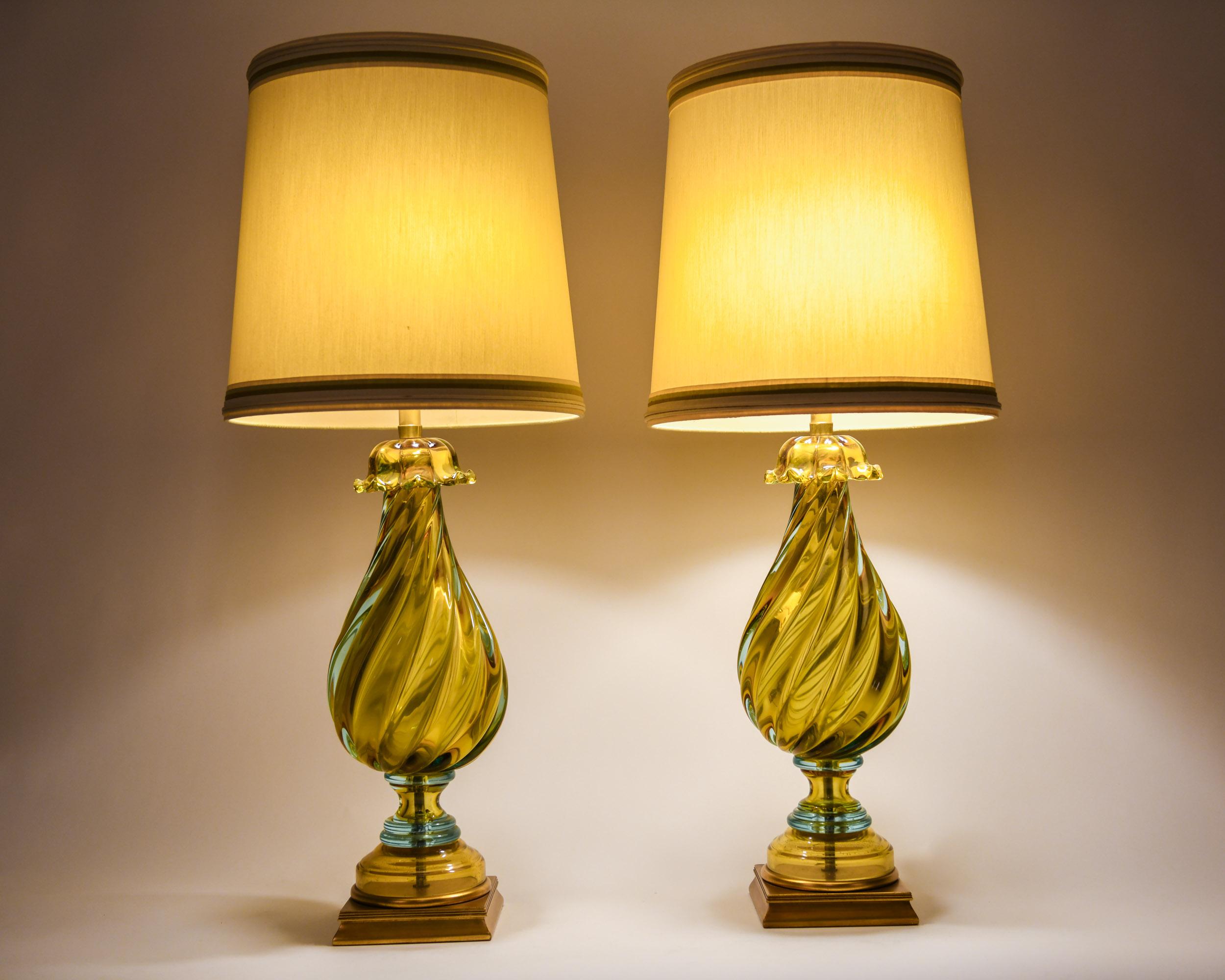 Early 20th century European art glass pair of table lamps with giltwood base. Each lamp is in excellent vintage working condition. Minor wear consistent with age or use. Maker's mark signed on harp. Measures: Each lamp measure about 38 inches from