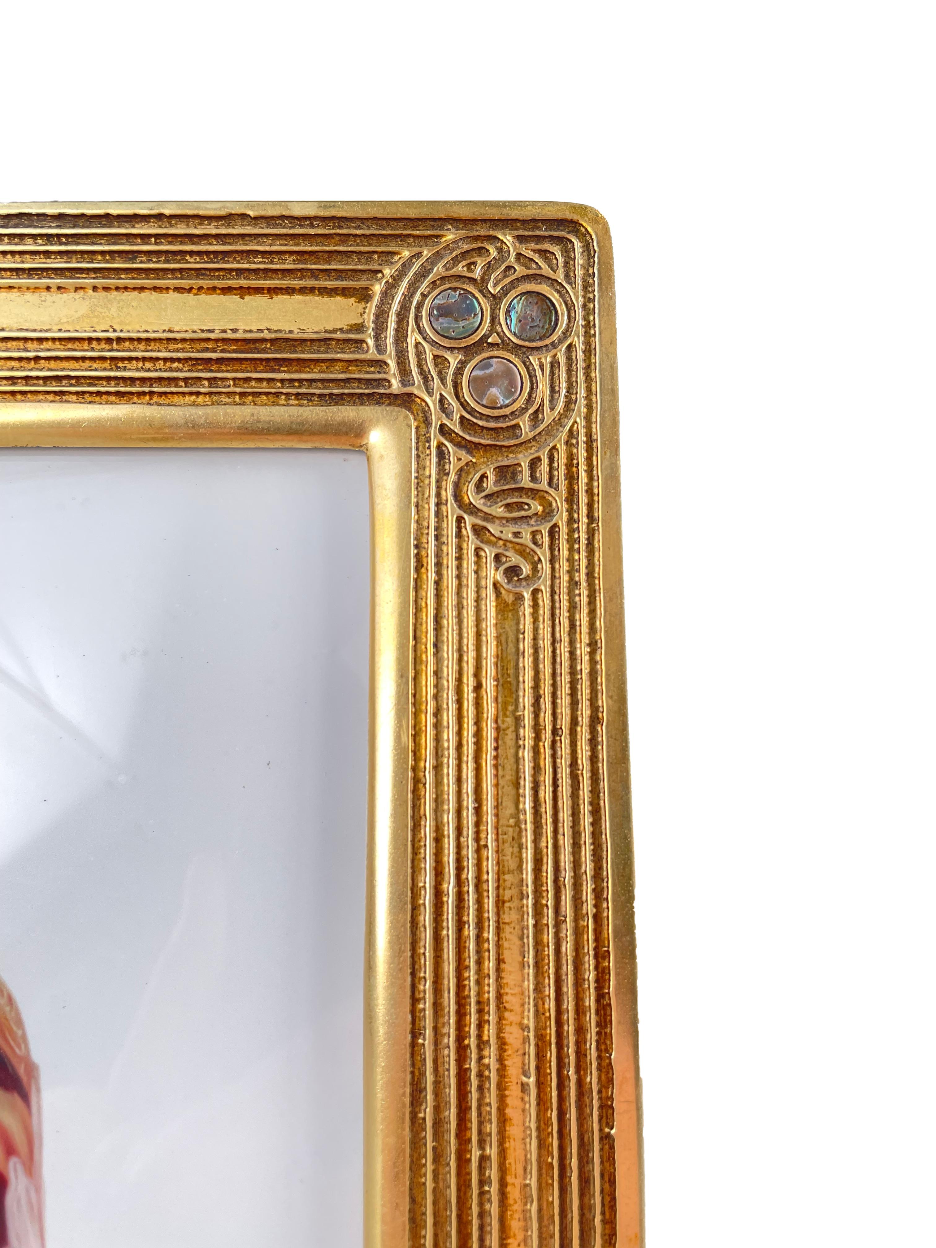 An early 20th century American Art Nouveau Abalone pattern picture frame by, Tiffany Studios decorated in the 'Abalone