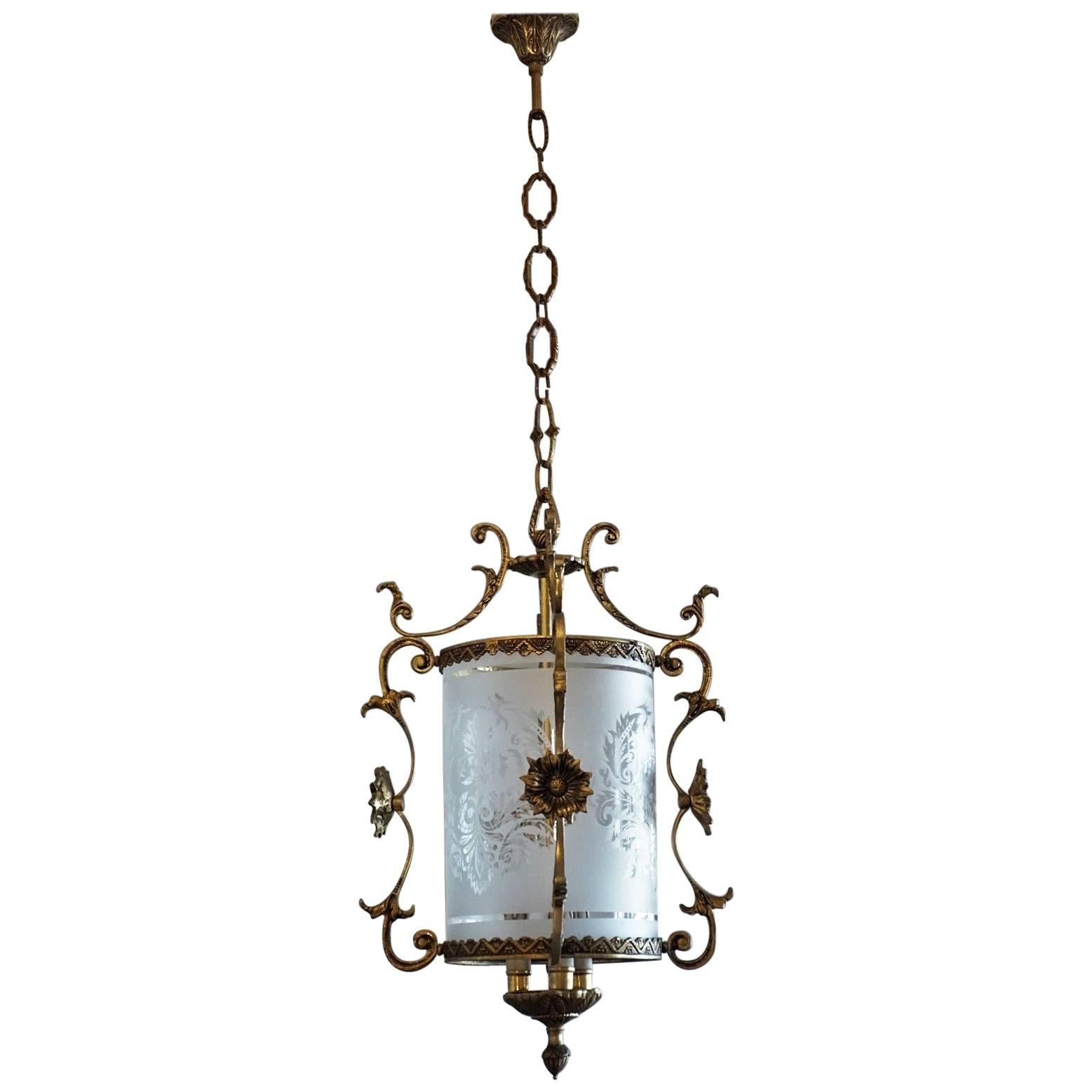 Early 20th century Art Nouveau bronze lantern with etched glass cylinder surrounded by four ornaments decorated with flowers and with integrated central three candle light bulb holder.
Measures: Total height 33 in (83 cm), variable
Height without