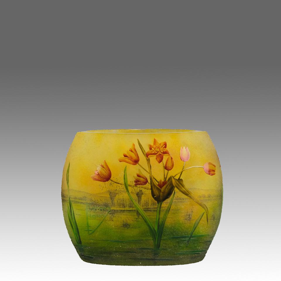 An attractive early 20th Century cameo pillow glass vase etched and enamelled with flowering poppies in a deep green and yellow landscape. Signed Daum Nancy and with the Cross of Lorraine
ADDITIONAL INFORMATION
Height:                               