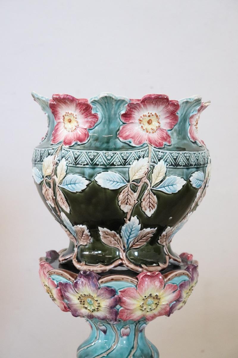 We present this splendid column vase, made in Italy, dating back to the early 20th century. The vase is crafted from polychrome glazed ceramic. The eye-catching decoration captures the eye with its magnificent, large, colorful flowers. The flowers