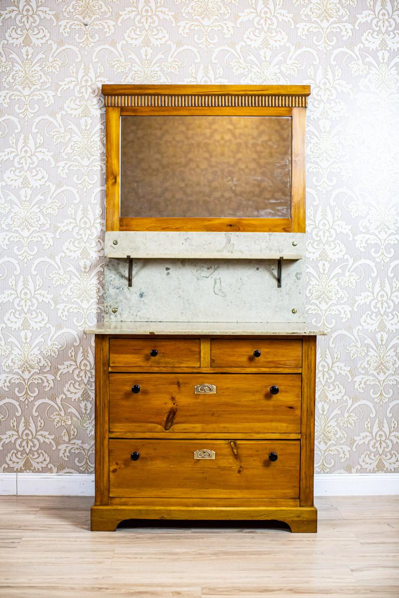 Early 20th-Century Art Nouveau Pine Commode Turned into Vanity

We present you an Art Nouveau pine commode, circa 1910.
The whole piece of furniture is composed of a base with four drawers covered above with a stone top and a stone wall with a shelf