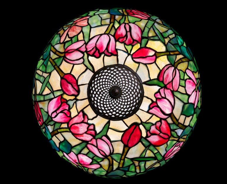 An Early 20th Century American Art Nouveau leaded stained glass, cast and patinated bronze 