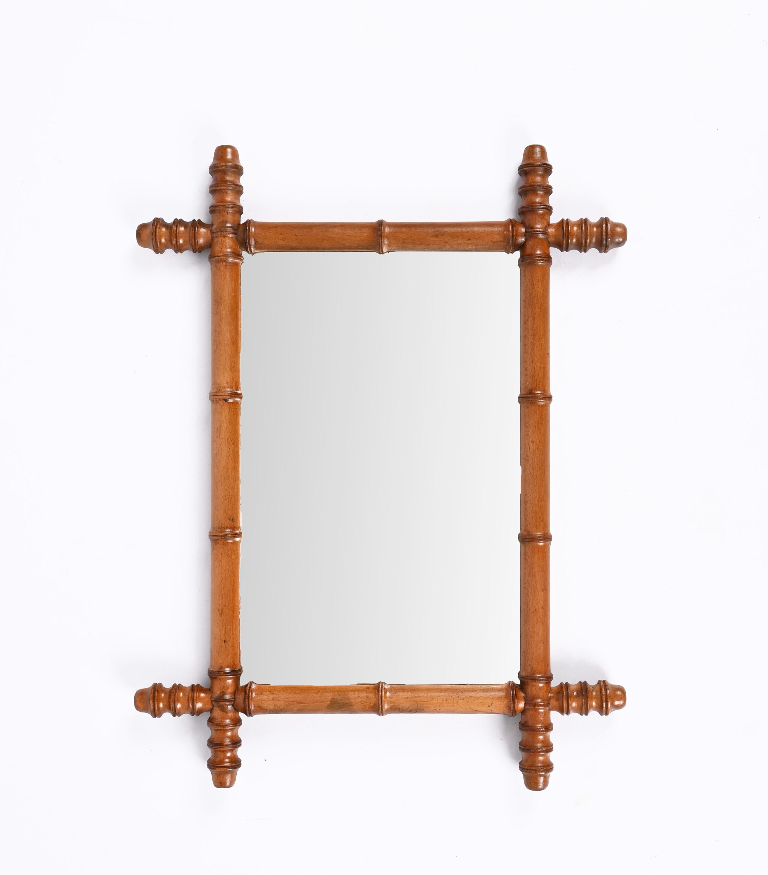 Early 20th century Art Nouveau mirror with beech faux bamboo frame. This wonderful item was produced in France in the 1900s.

This piece is very attractive thanks to the patina of glass plate and the faux bamboo frame, made of beech.

With its
