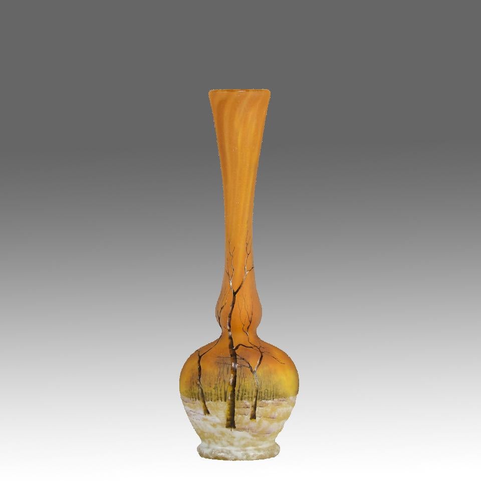 A beautiful early 20th Century solifleur cameo glass vase etched and enamelled with a snowy forest landscape against a warm orange field, with excellent colour and detail. Signed Daum Nancy and with the Cross of Lorraine
ADDITIONAL
