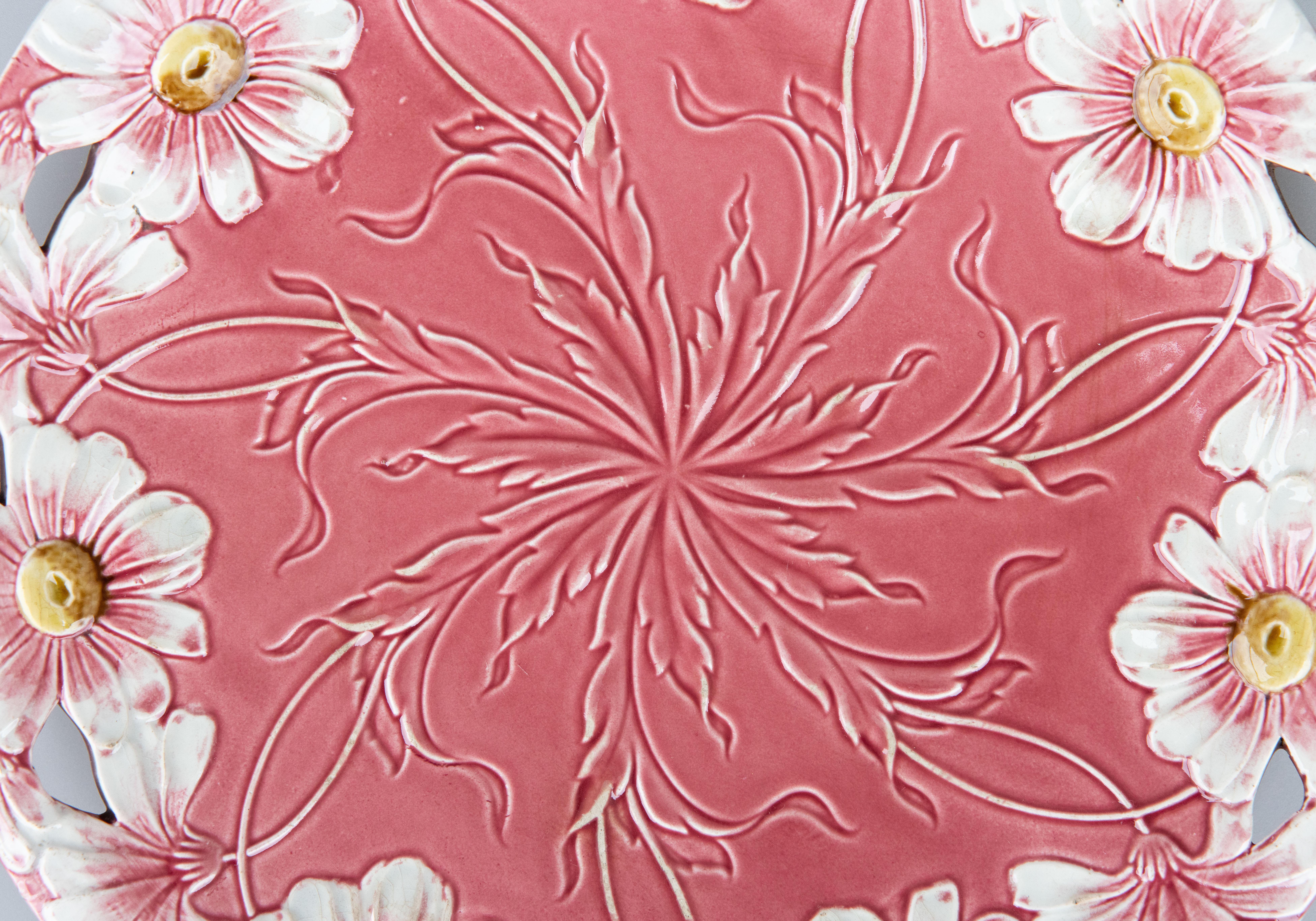 A lovely antique Art Nouveau style majolica pink daisies floral charger plate. This gorgeous plate is hand painted with daisies and a reticulated design. It is a nice large size with stunning colors and displays beautifully.