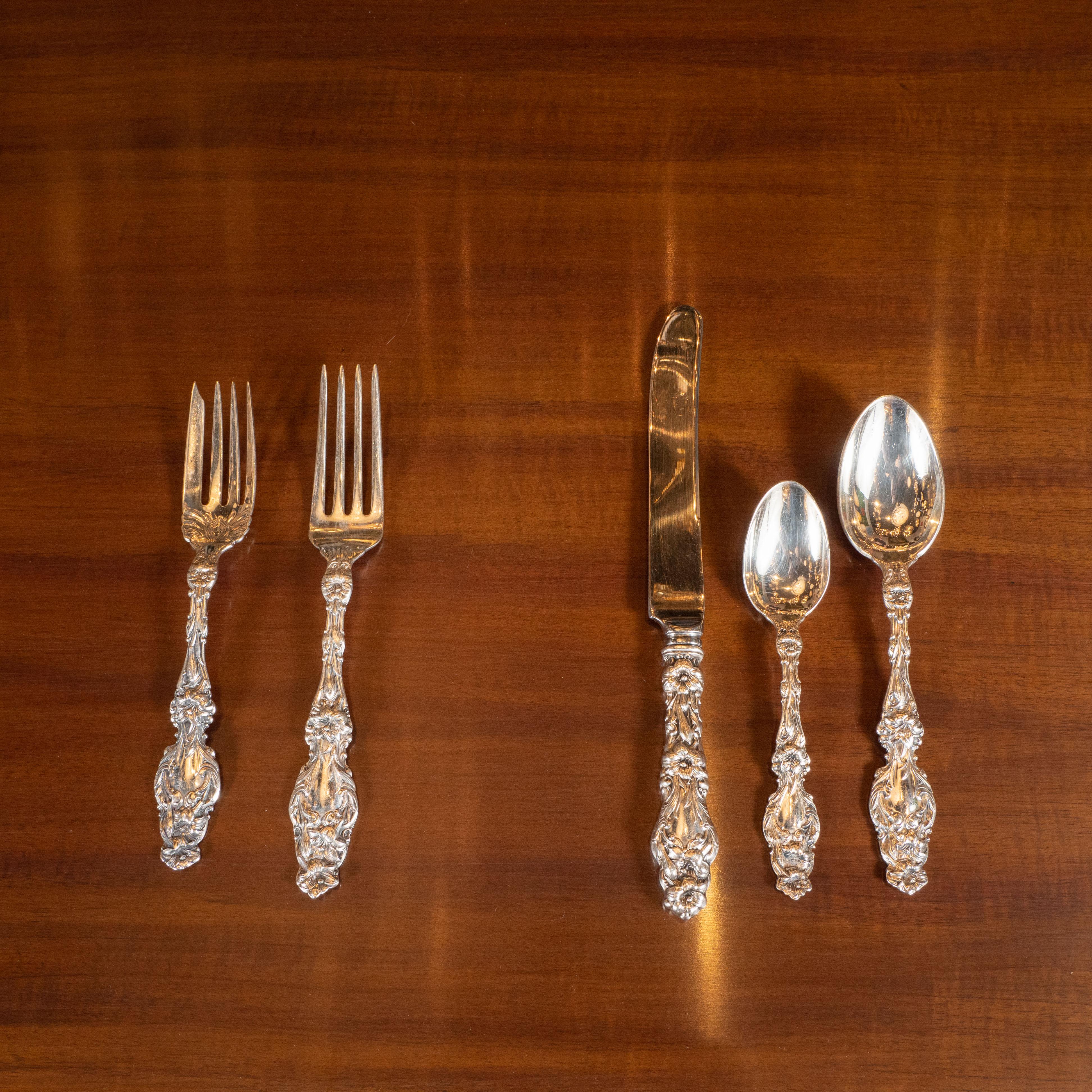 This elegant and ornate Art Nouveau sterling silver flatware service for 12 was forged by the artisans at Gorham in the early 20th century. Gorham, which was founded in 1831 grew to be one of the United States' most prestigious silver manufacturers
