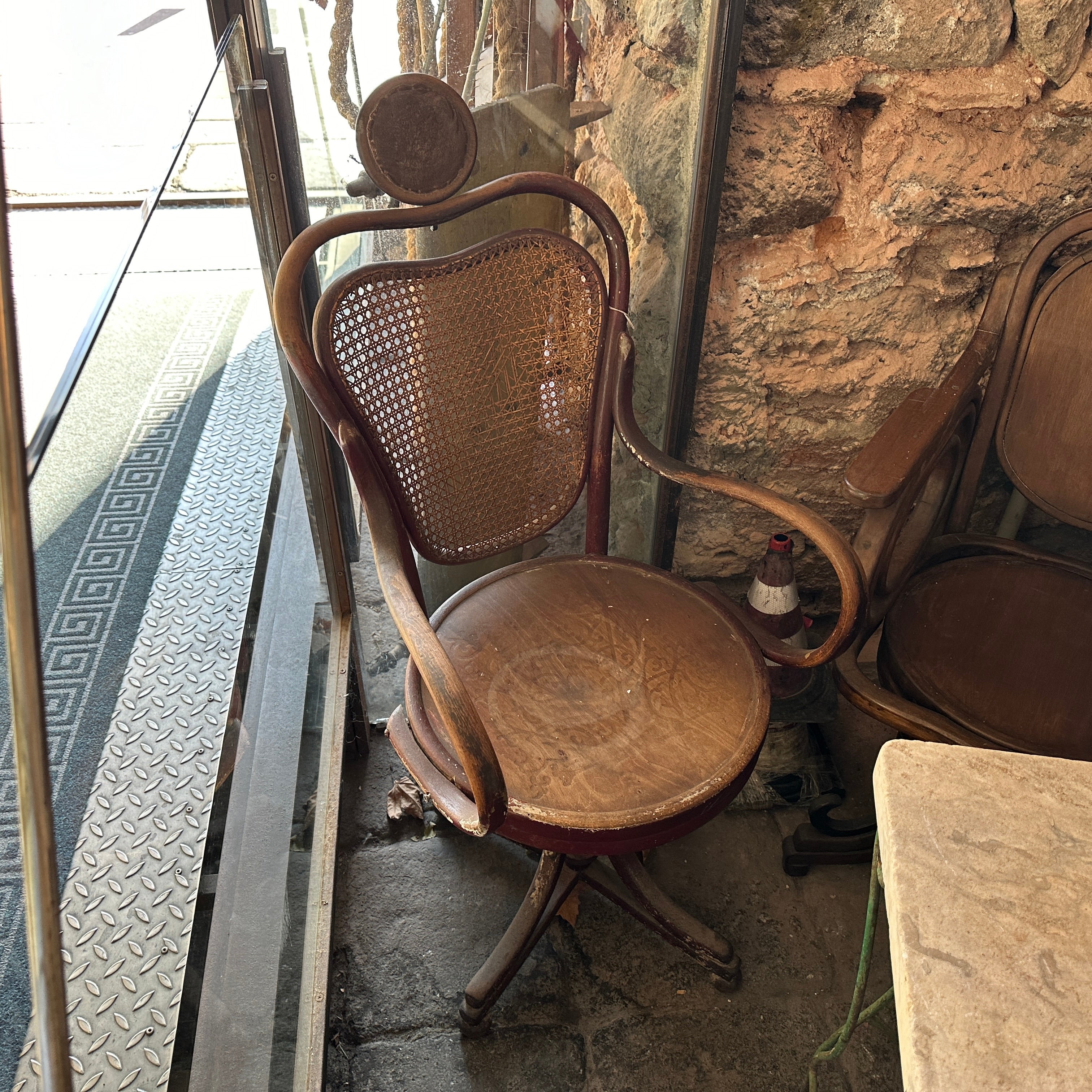 An early 20th Century Antique swivel Barber Chair hand-crafted in Italy. Wood and Wicker are in orginal condition and needs restoration. It has been hand-carved and crafted in Palermo in Sicily. This Chair is a stunning example of craftsmanship and