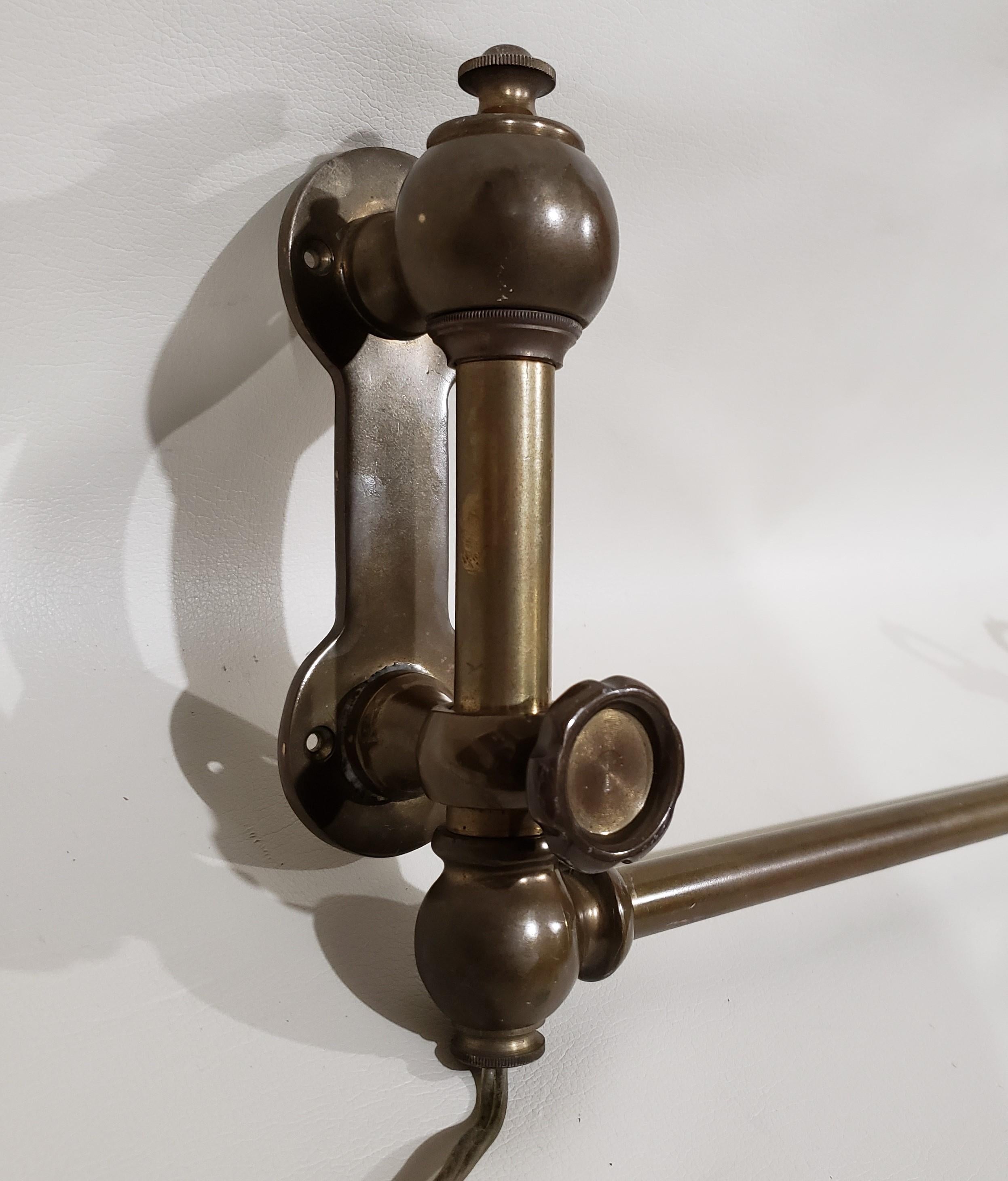 Unique wall mounted light which originally adorned the walls of a train. This brass light with a beautiful rich patina easily extends and adjusts to a multitude of positions.