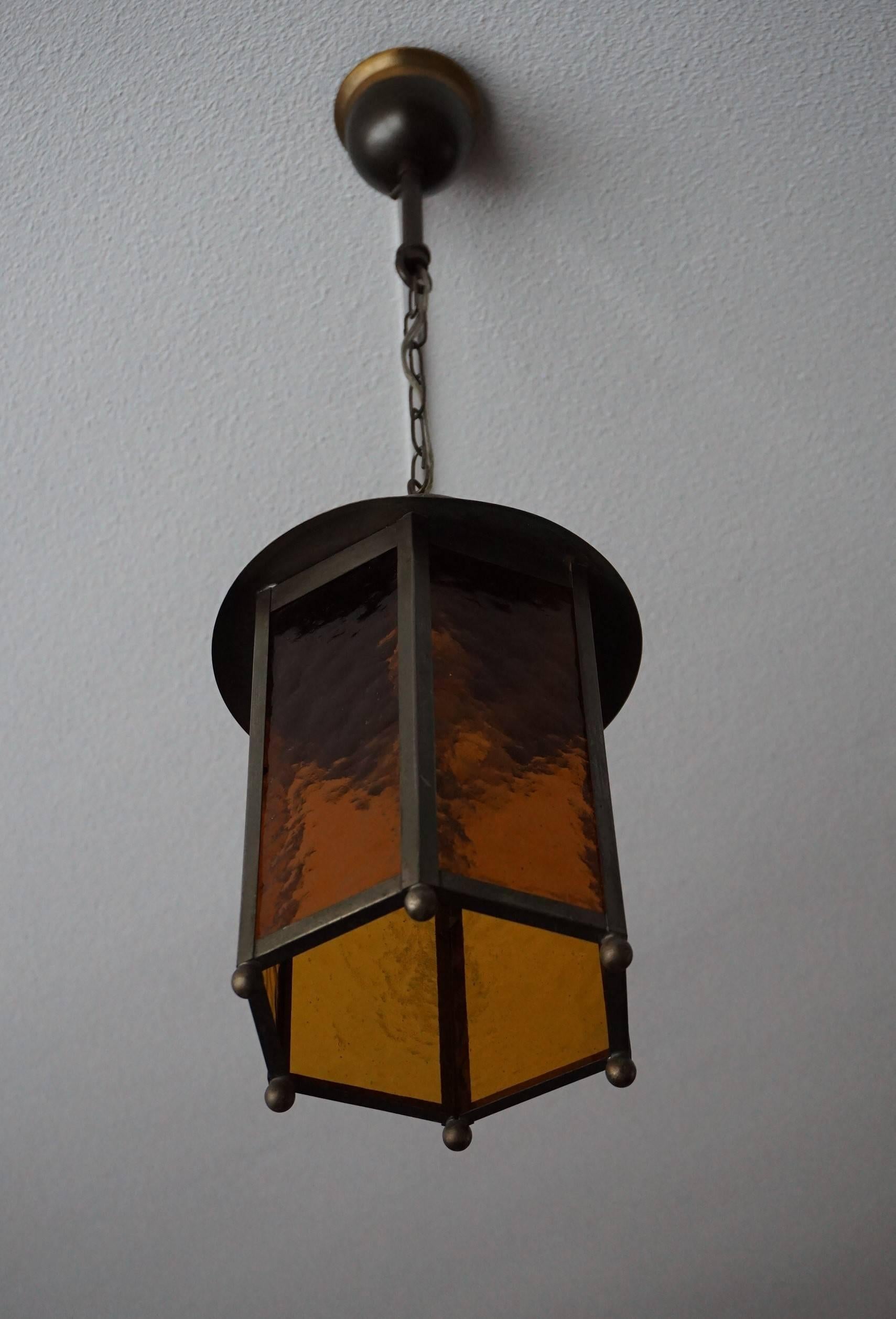 Perfect shape and condition, amber color hall ceiling lamp.

This beautiful Arts & Crafts light fixture could not be in a better condition and the warm light it radiates will bring the perfect atmosphere to your entrance or hallway. The brass frame