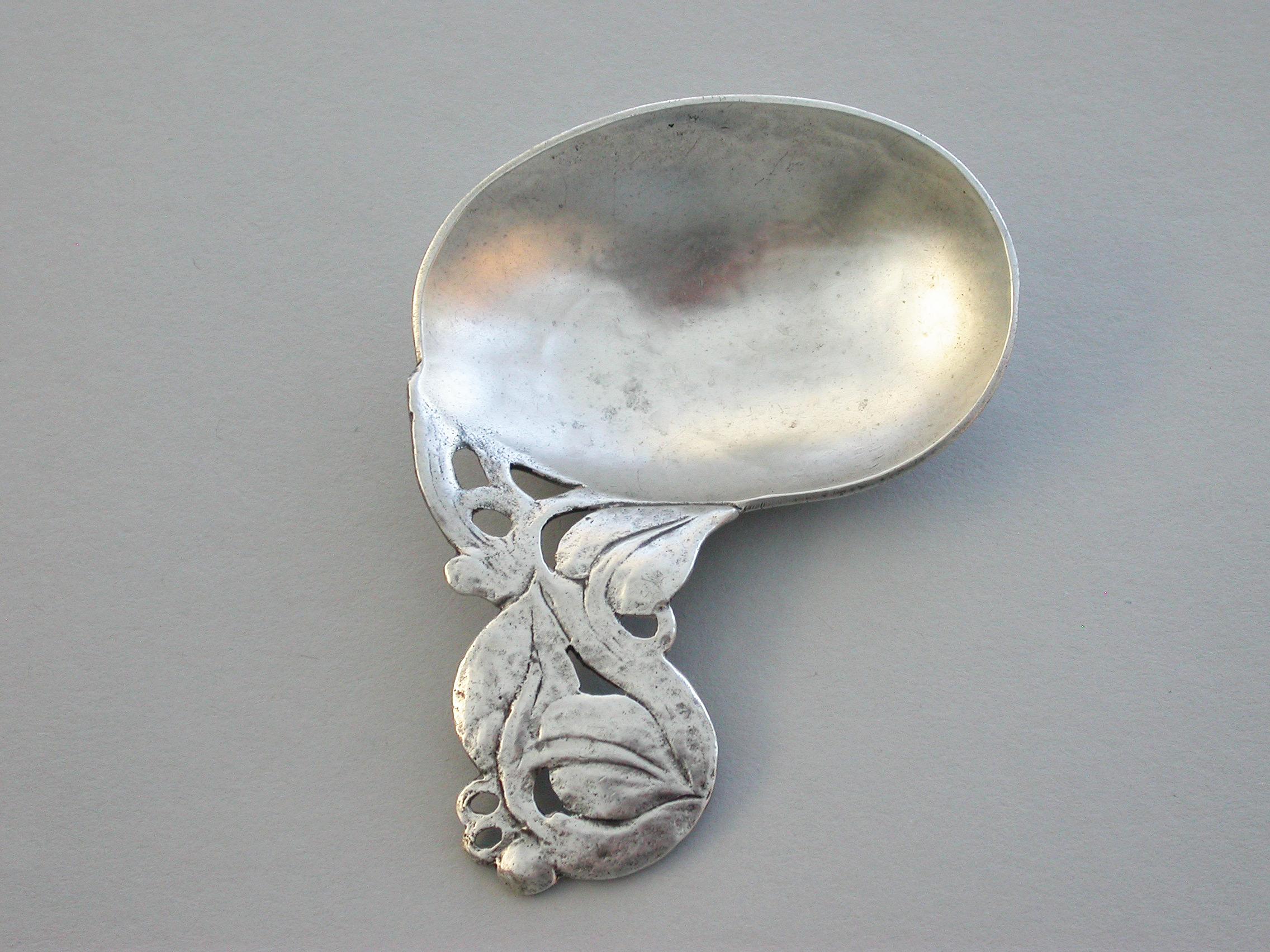 A good quality early 20th century hammered silver Caddy Spoon made in the Arts & Crafts style, with oval bowl and pierced entwined leaf and berry handle.

By Bernard Instone, Birmingham, 1927

24.50 grams (0.79 troy ounces).

 