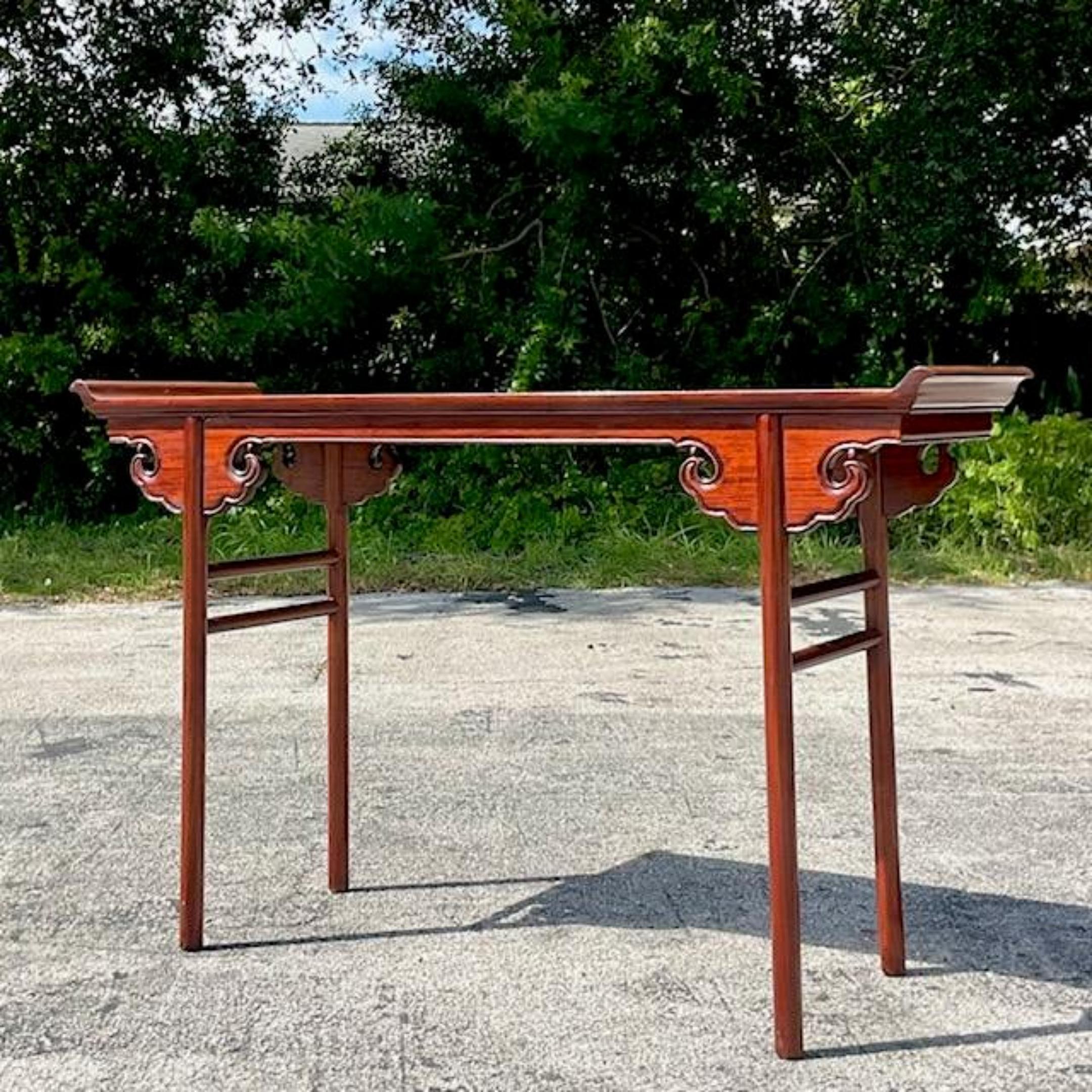 A fabulous vintage Asian console table. Chic pagoda wing design with beautiful hand carved detail. Acquired from a Palm Beach estate.