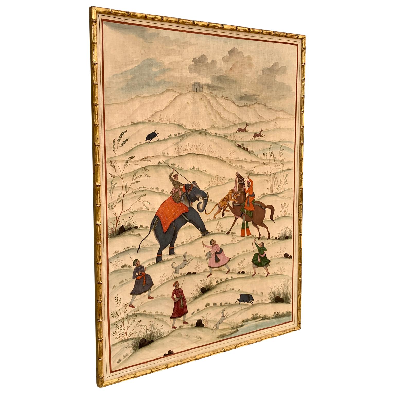 A hand-painted work of art on silk from former Persia or India representing a tiger hunt in a wild hill landscape. Framed in a gilt bamboo imitation matching frame uptight on a panel. Animals in this scene include elephants, tiger, wild boars, dogs,