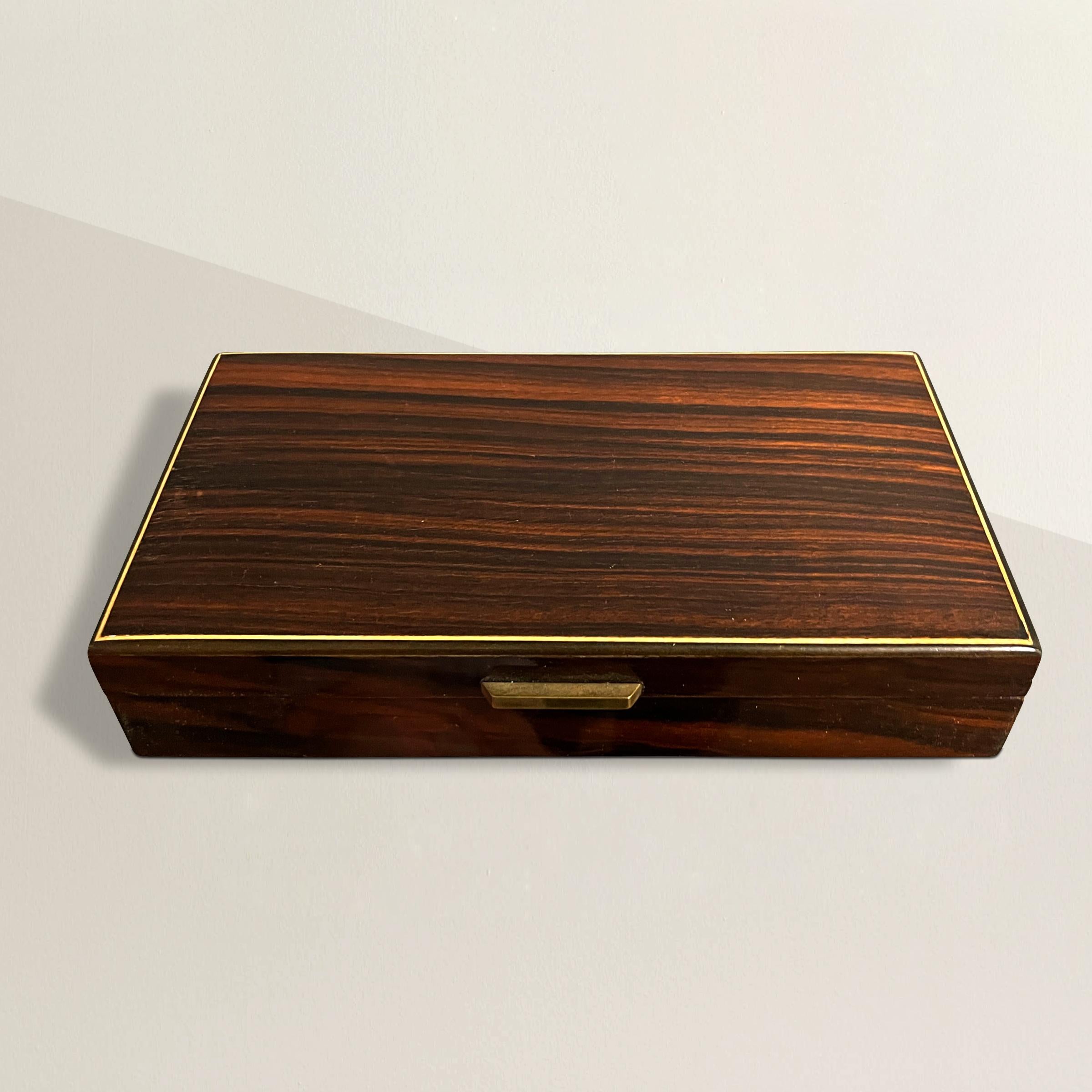 A striking early 20th century Austrian box with ebony veneer over birch and with a thin fruitwood inlaid stripe around the lid. A simple brass handle allows the lid to be opened. Perfect for storing playing cards, keys, coins, or any other myriad