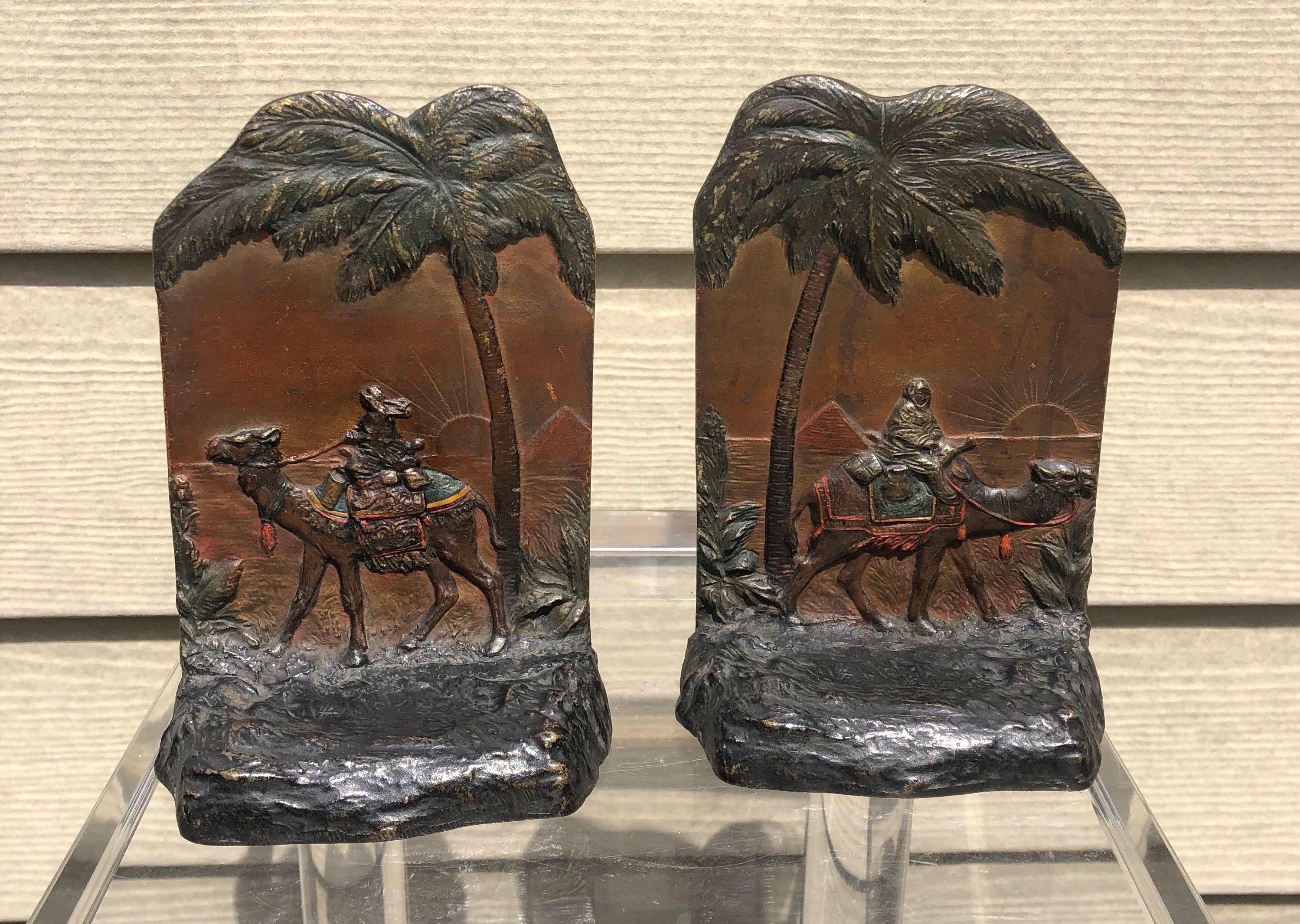 Beautiful early 20th century Austrian cold painted polychrome bookends depicting Egyptian pyramids, palm trees and camelback trader. Fantastic quality and patina.