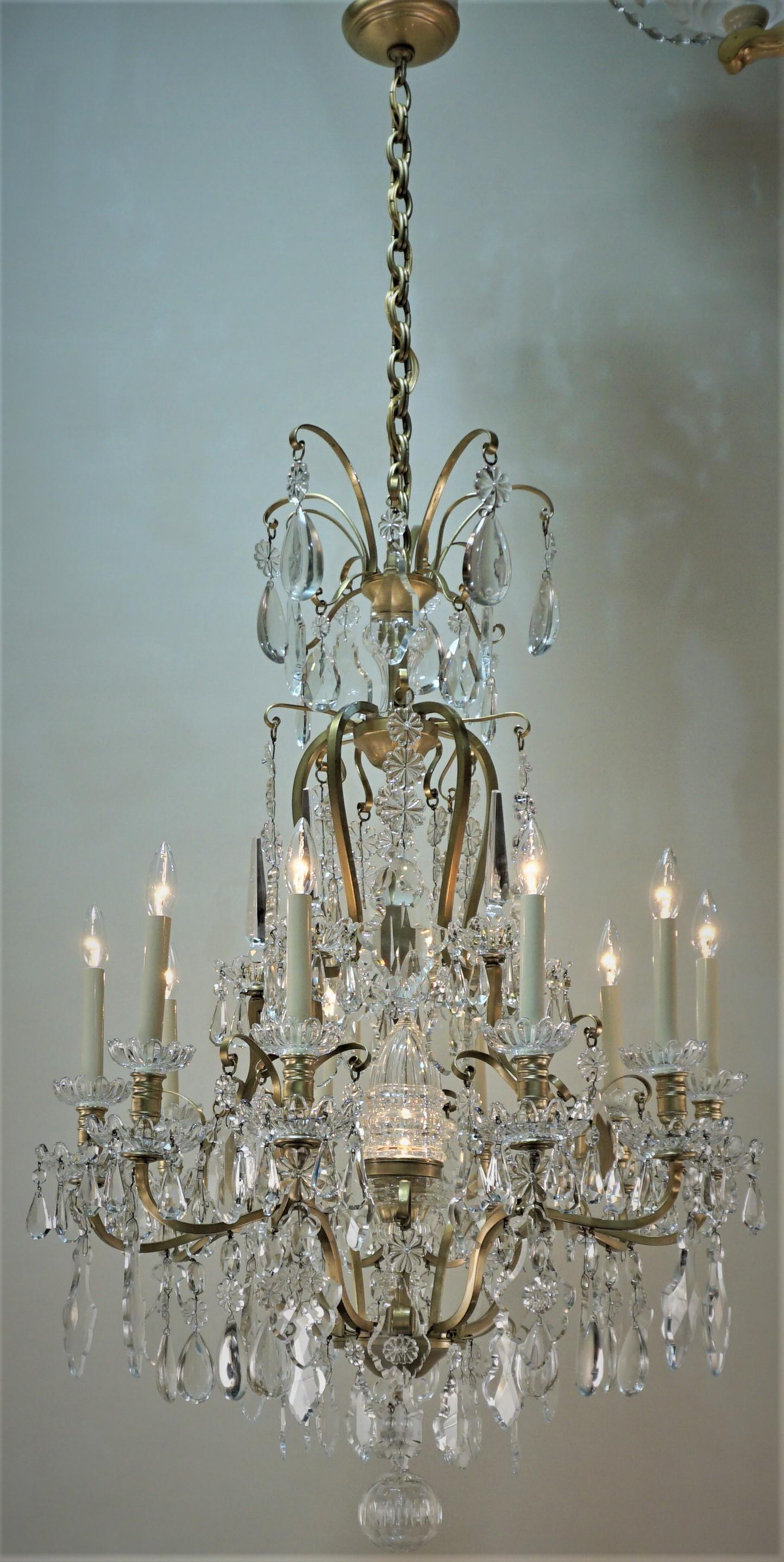 Fabulous early 20th century Baccarat crystal and bronze chandelier with ten candle lights and one center light that is house in a beautiful glass shade.
31