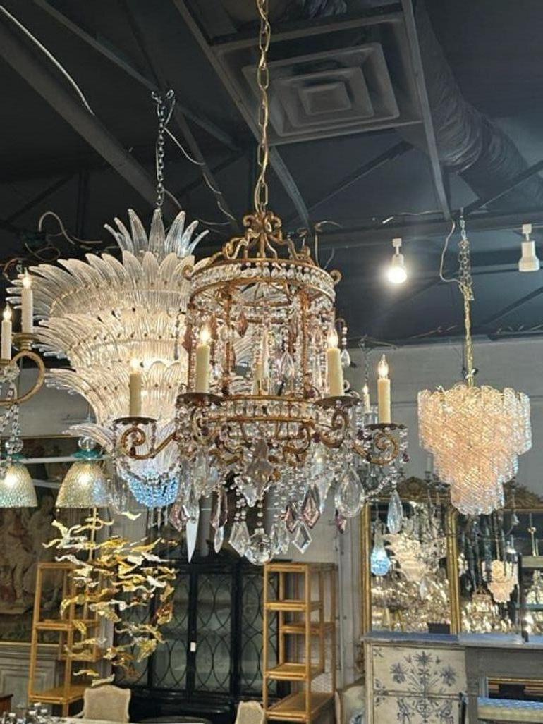 Gorgeous early 20th century Bagues manner chandelier. Great birdcage shaped base covered in crystals including some that are amethyst colored. Very special!!