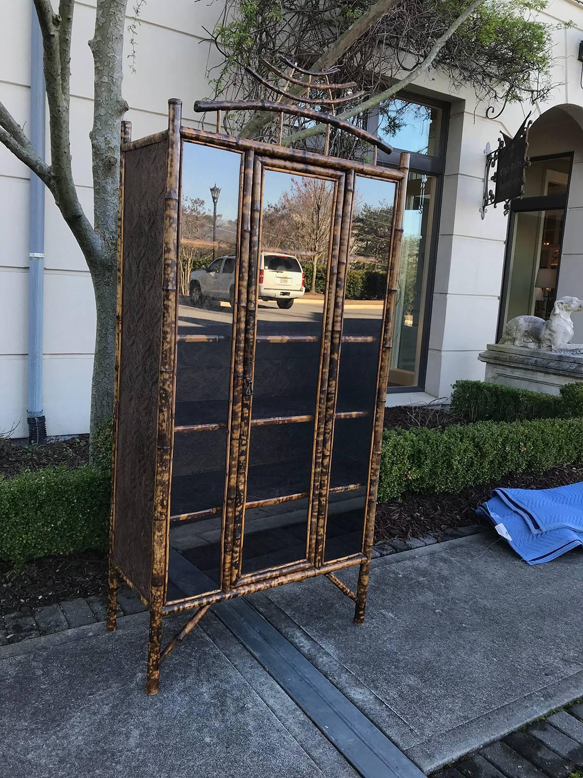 Early 20th century bamboo cabinet, glass door, five shelves.