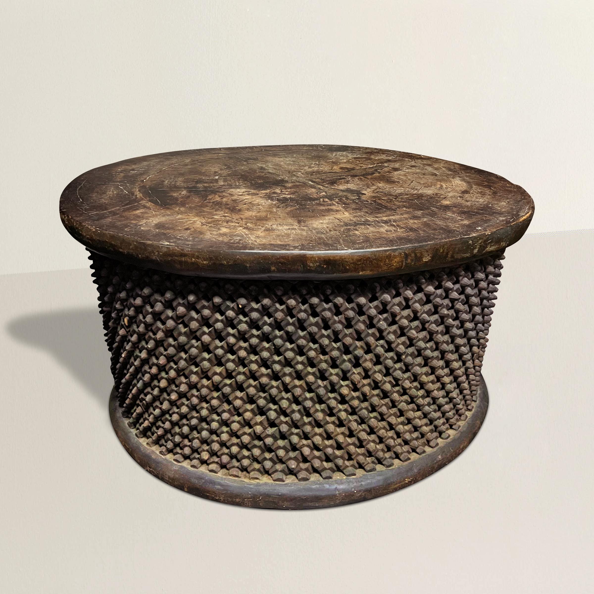 The finest and largest early 20th century Bamileke table we've ever seen! Featuring the most intricately carved 'spider' patterned sides with a wonderful flat, smooth, worn top, this table is carved from a single piece of wood. The perfect coffee