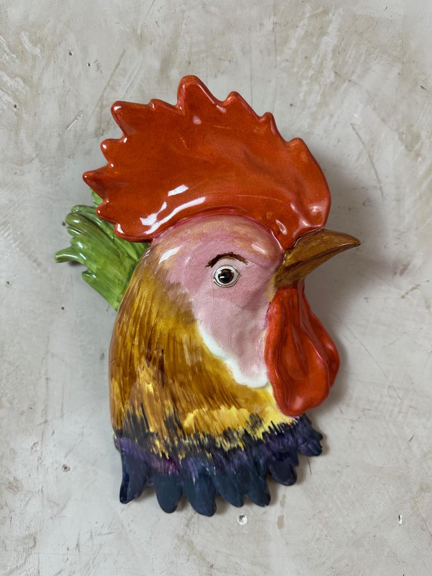 Beautiful wall flower pot representing a red-crested rooster's head. 
Dates from the early 20th century.
Beautiful, bright colors. Holes in the back for hanging the flower pot. The back was broken but has been glued back together.
Good overall
