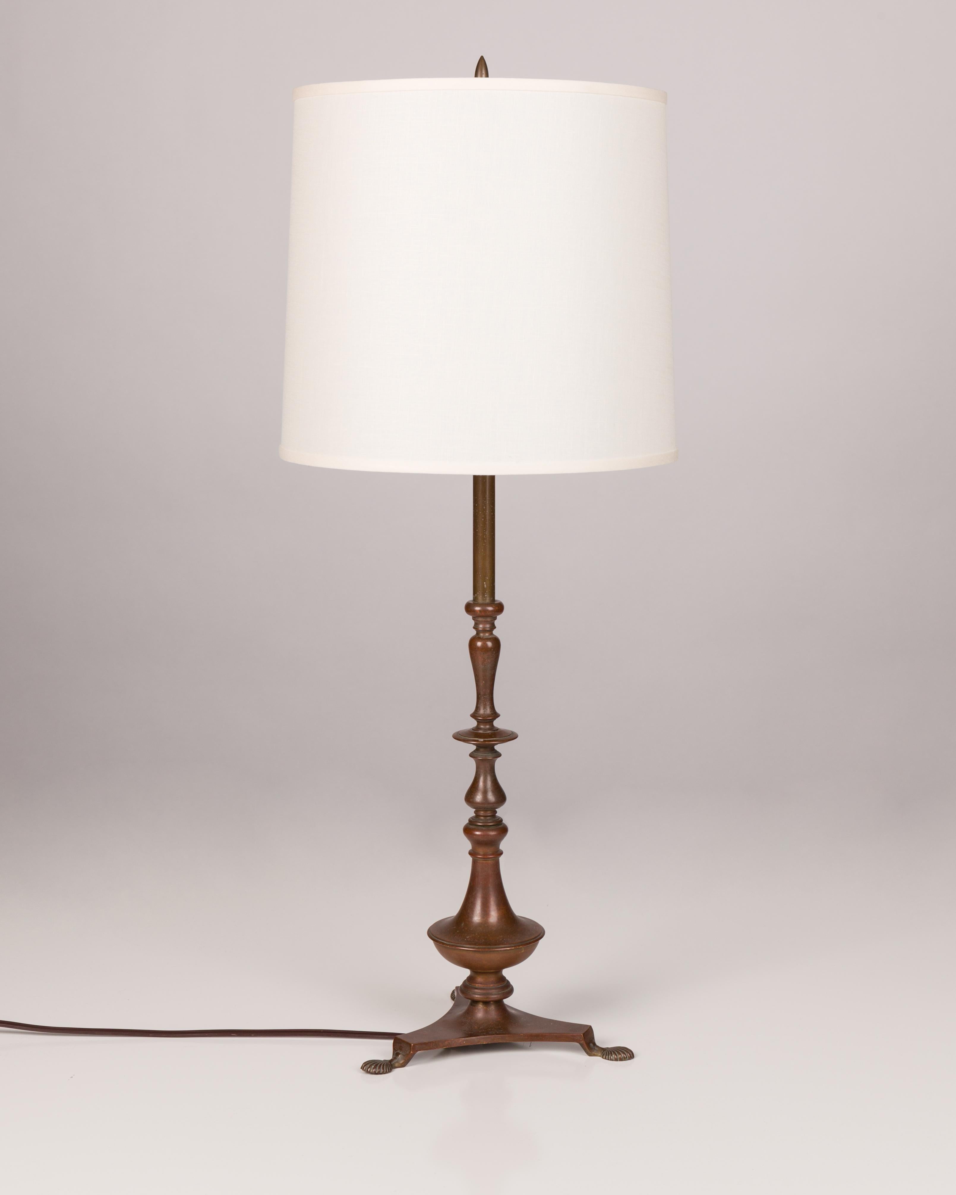 ATL1851
A baroque turned brass table lamp with a tripod base in its original aged bronze patina. Circa 1900. The 12