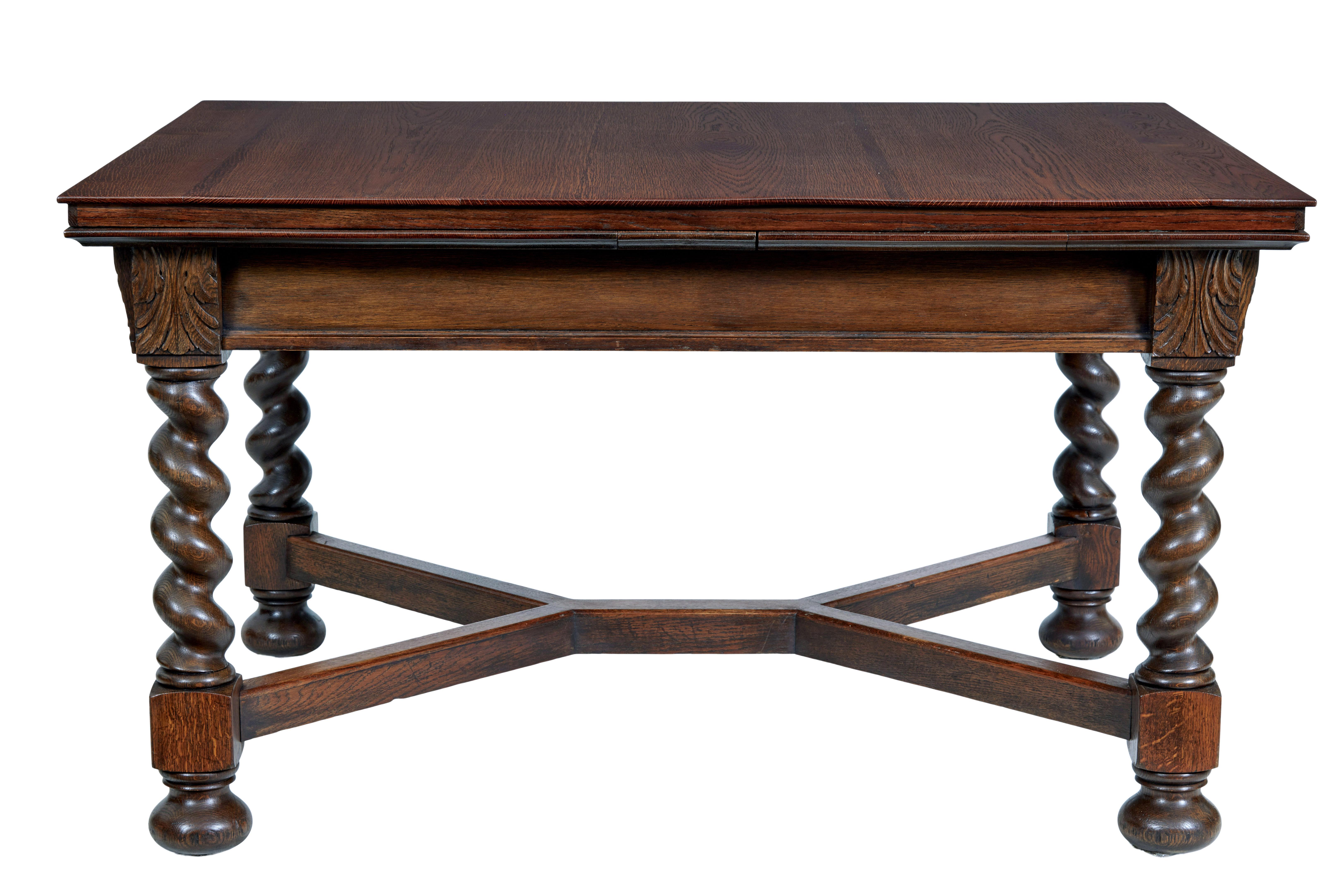 Early 20th century baroque revival oak extending dining table circa 1900.

Swedish made oak drawleaf table, with a pull out pine slide each end, to allow this table to seat a comfortable 10.  Carved acanthus leaf detail on each corner of the apron. 