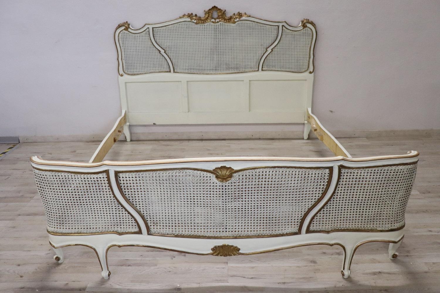 Incredibly rare this French Baroque style double bed made in early 20th century .Completely in lacquered wood with refined gilded decorations. Characterized by a typically Baroque wavy line. Of great value is the decoration in Vienna straw woven by